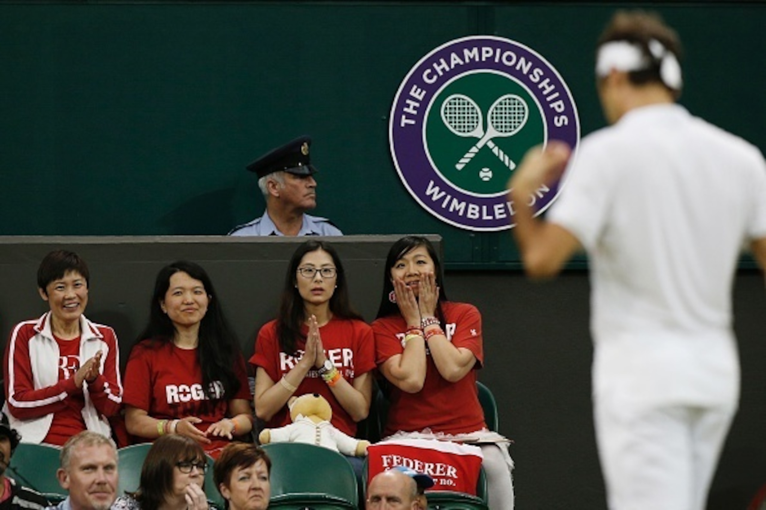 Fans of Roger Federer watch as Switzerland's Roger Federer plays Britain's Daniel Evans during their men's singles third round match on the fifth day of the 2016 Wimbledon Championships at The All England Lawn Tennis Club in Wimbledon, southwest London, o Fans of Roger Federer watch as Switzerland's Roger Federer plays Britain's Daniel Evans during their men's singles third round match on the fifth day of the 2016 Wimbledon Championships at The All England Lawn Tennis Club in Wimbledon, southwest London, o