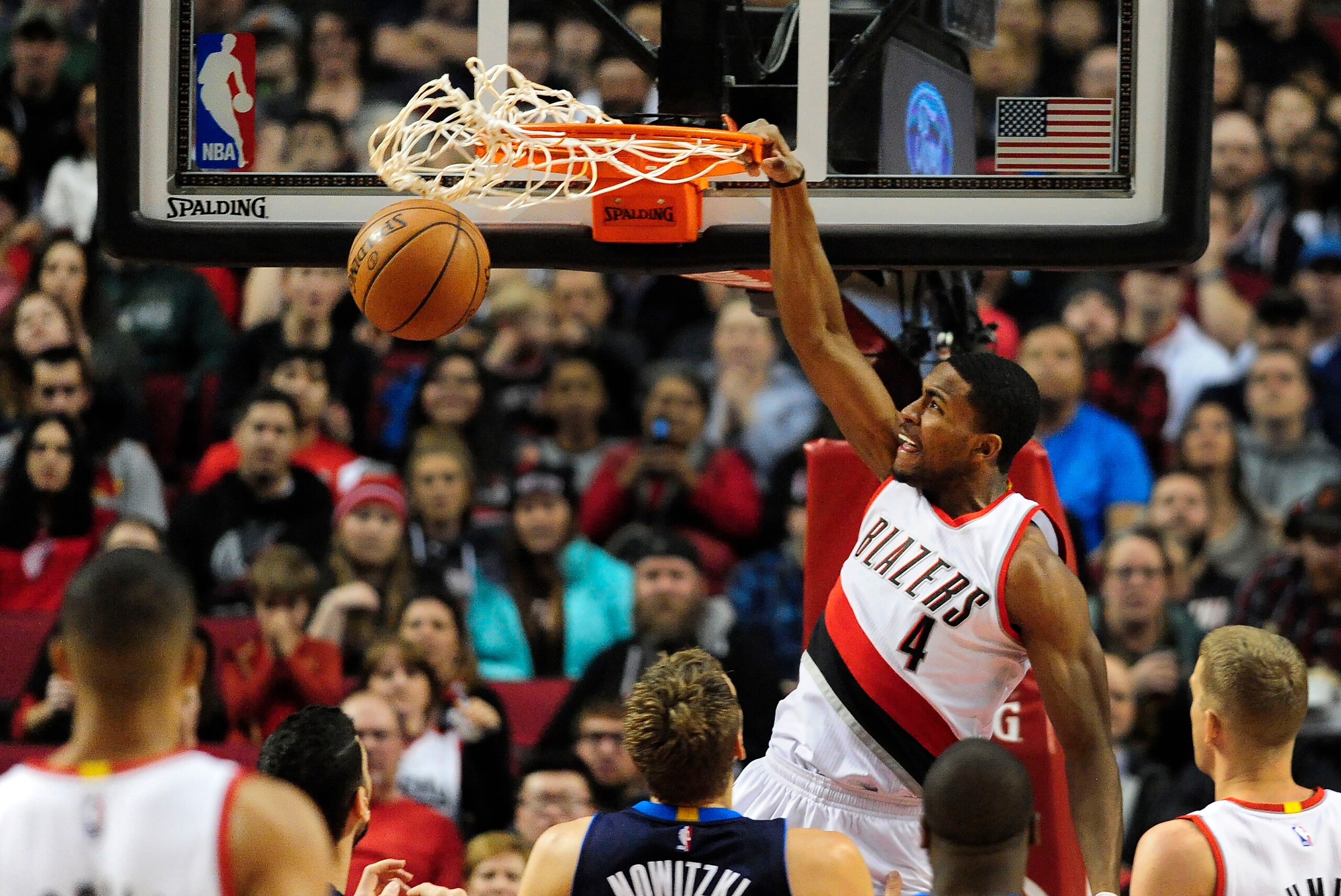 Mar 23, 2016; Portland, OR, USA; Portland Trail Blazers forward Maurice Harkless (4) dunks the ball against Dallas Mavericks forward Dirk Nowitzki (41) during the first quarter of the game at Moda Center at the Rose Quarter. Mandatory Credit: Steve Dykes-