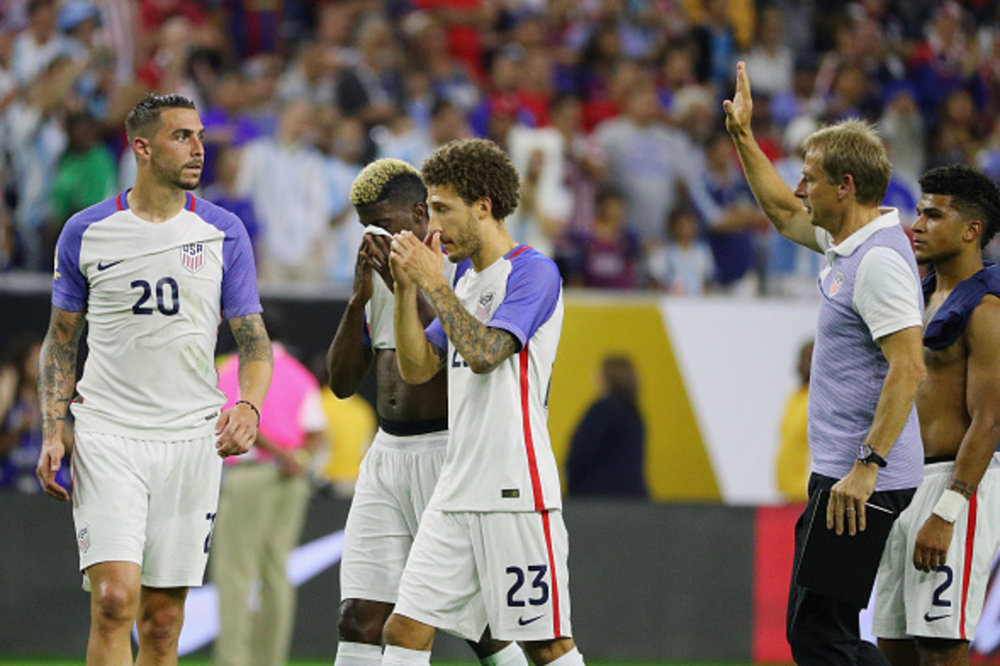 HOUSTON, TX - JUNE 21:  United States manager Jurgen Klinsmann (R) walks across the pitch with a group of players after losing their game against Argentina 4-0 during a 2016 Copa America Centenario Semifinal match at NRG Stadium on June 21, 2016 in Housto