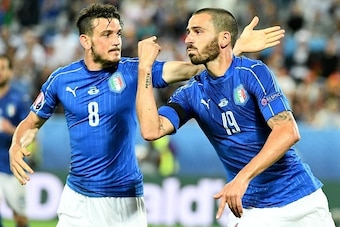 Italy's defender Leonardo Bonucci (R) celebrates with Italy's midfielder Alessandro Florenzi after scoring a penalty shot giving Italy their first goal of the match during the Euro 2016 quarter-final football match between Germany and Italy at the Matmut 