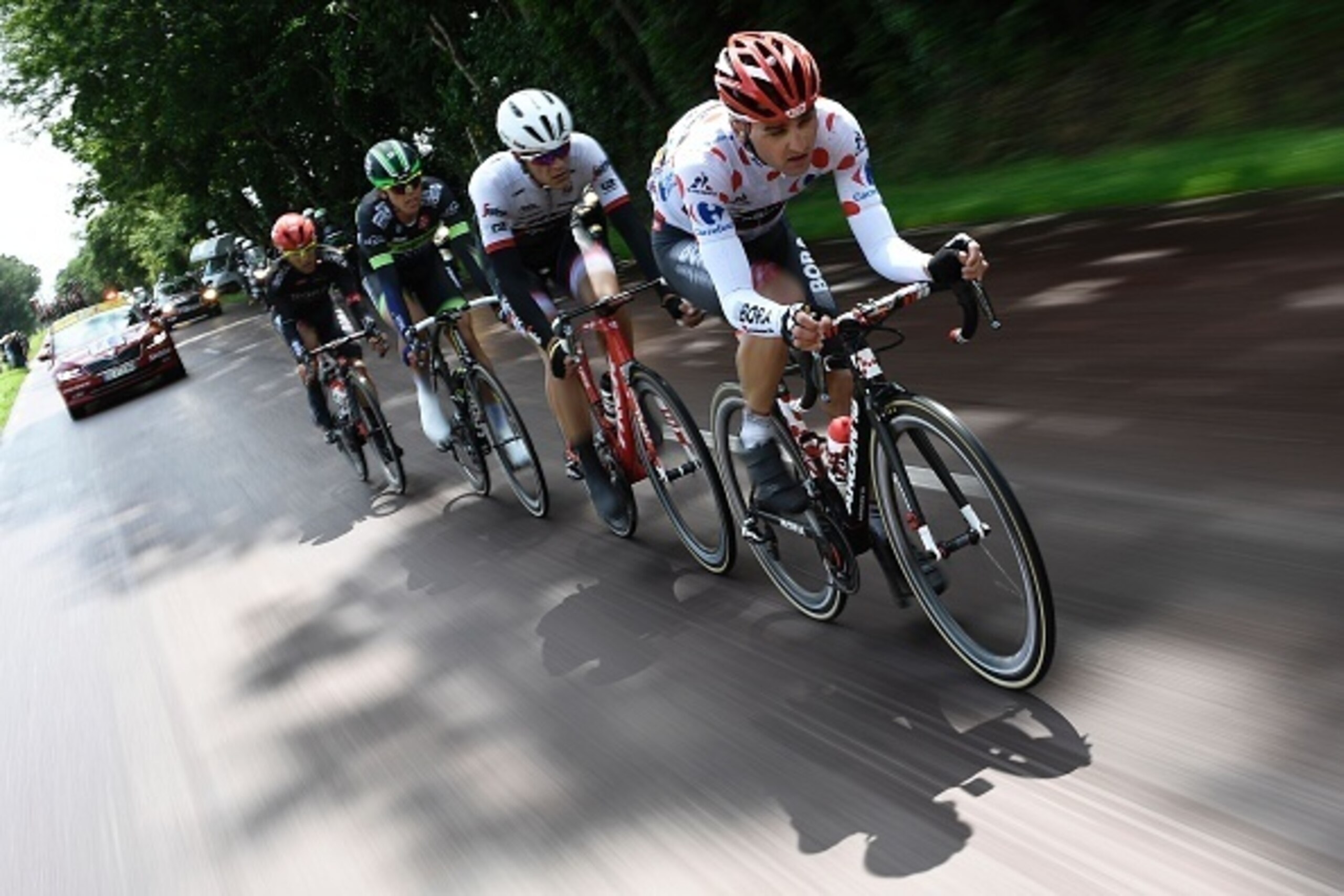 (From R) Germany's Paul Voss, wearing the best climber's polka dot jersey, Belgium's Jasper Stuyven, Norway's Vegard Breen and Italy's Cesare Benedetti ride in a breakaway during the 183 km second stage of the 103rd edition of the Tour de France cycling r