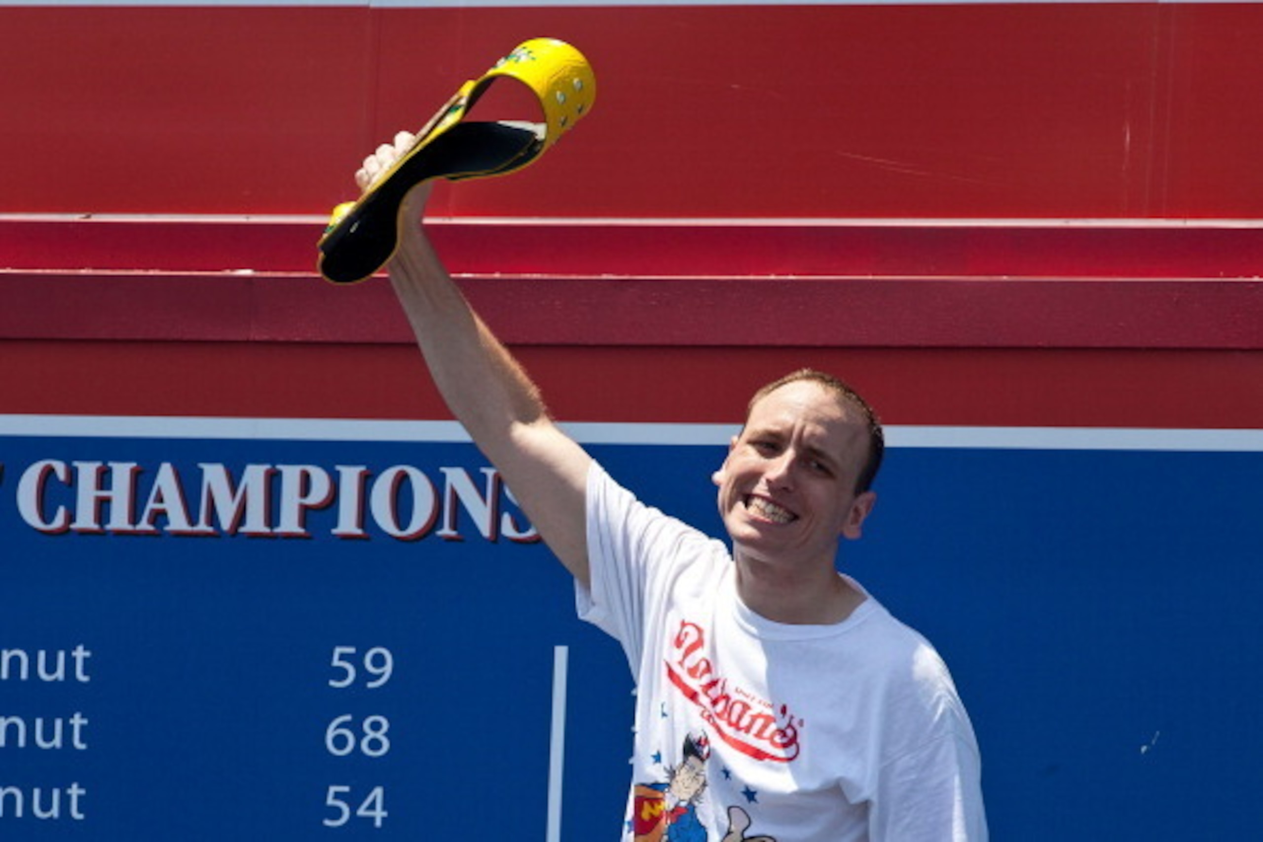 NEW YORK, NY - JULY 04:  Competitive eater Joey Chestnut waves to the crowd before competing in the Nathan's Famous International Hot Dog Eating Contest at Coney Island on July 4, 2012 in the Brooklyn borough of New York City. Chestnut won the men's divis