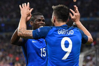 PARIS, FRANCE - JULY 03:  Olivier Giroud (R) of France celebrates scoring his team's fifth goal with his team mate Paul Pogba (L) during the UEFA EURO 2016 quarter final match between France and Iceland at Stade de France on July 3, 2016 in Paris, France.