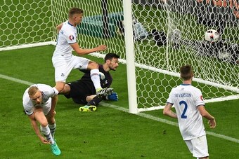 Iceland's forward Kolbeinn Sigthorsson (C) reacts after scoring his team's first goalin the nets of France's goalkeeper Hugo Lloris during the Euro 2016 quarter-final football match between France and Iceland at the Stade de France in Saint-Denis, near Pa