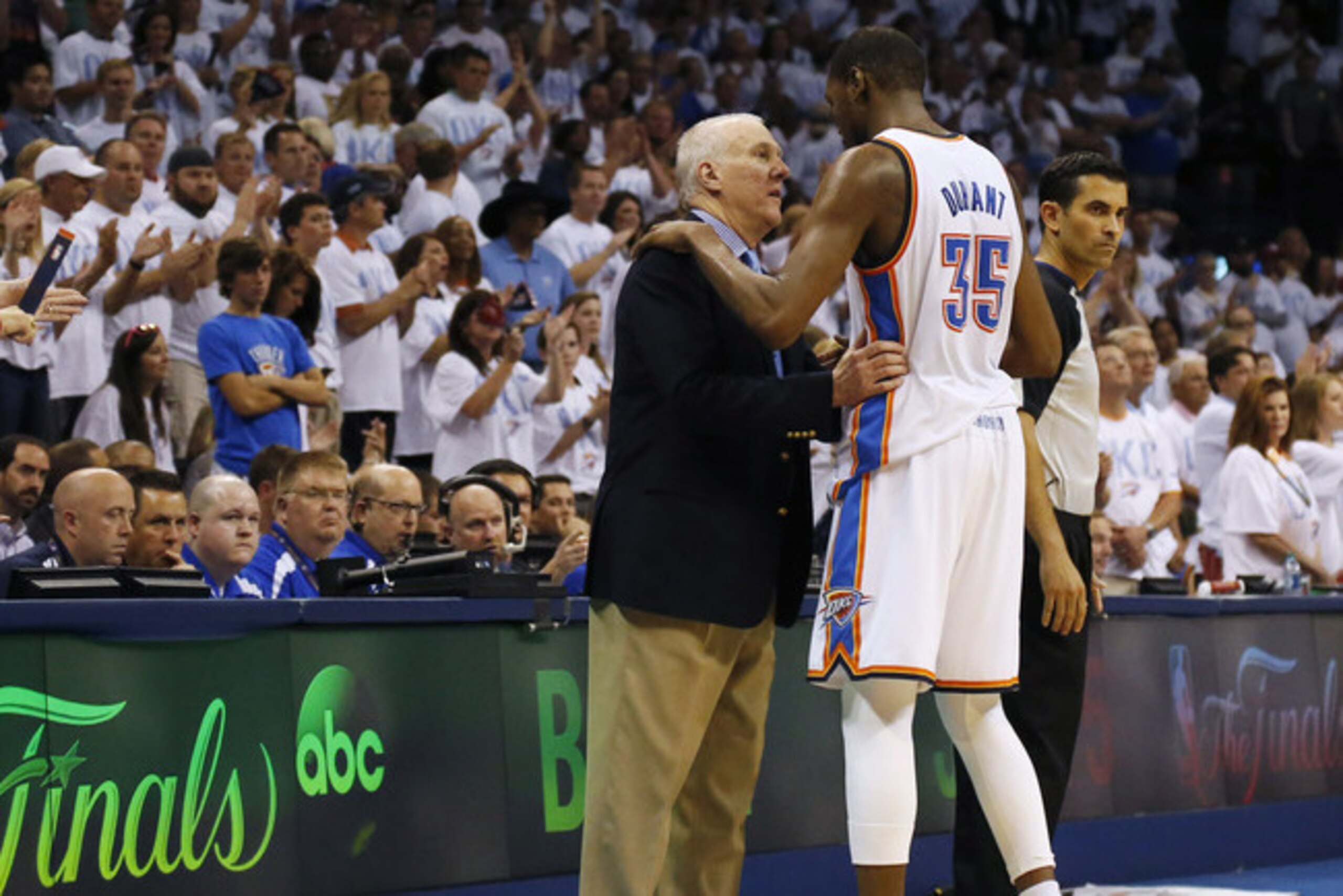 San Antonio Spurs head coach Gregg Popovich shares a moment with Kevin Durant during their 2014 playoff series.