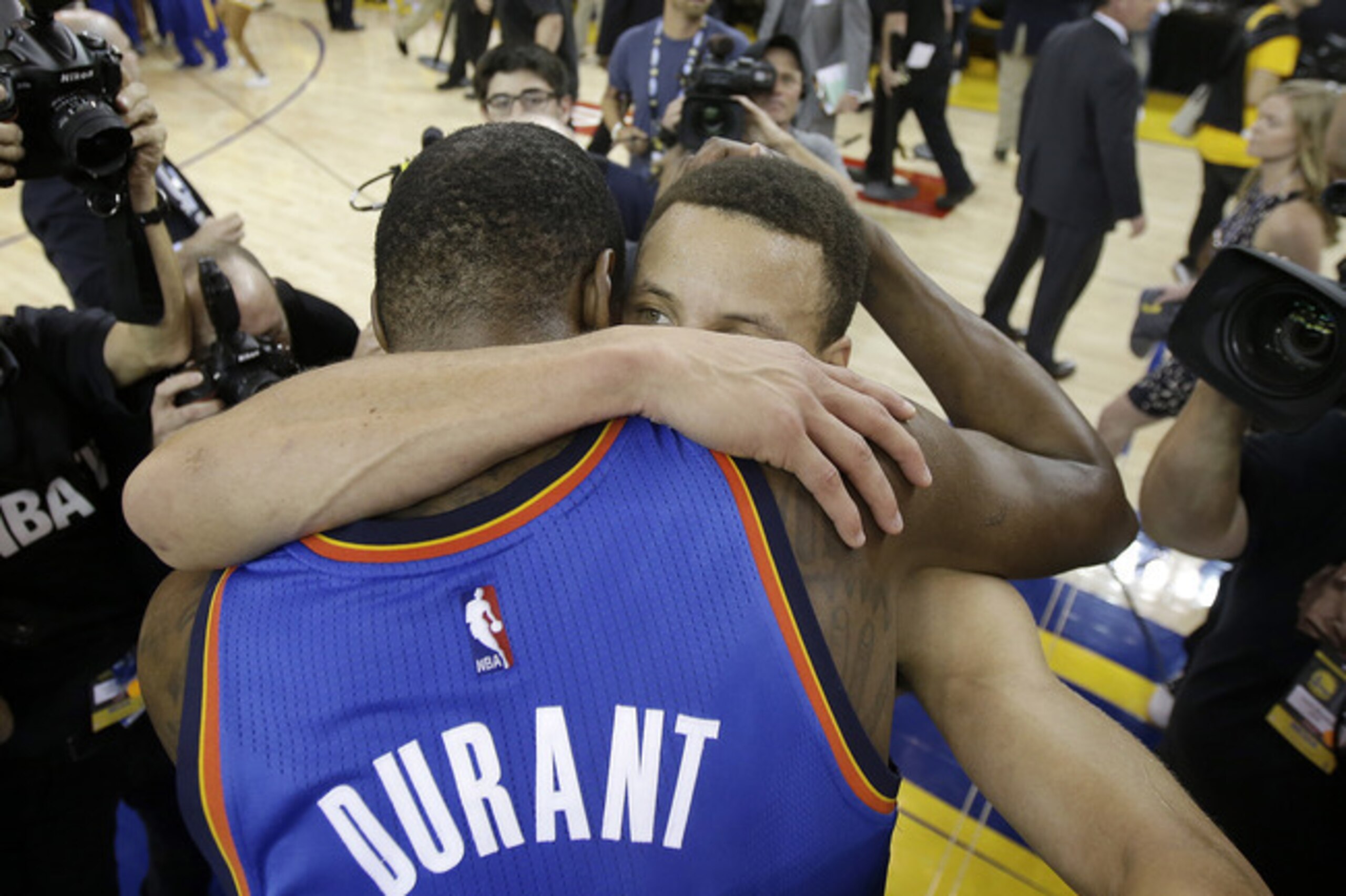 Kevin Durant and Steph Curry embrace after their 2016 Western Conference playoff series.
