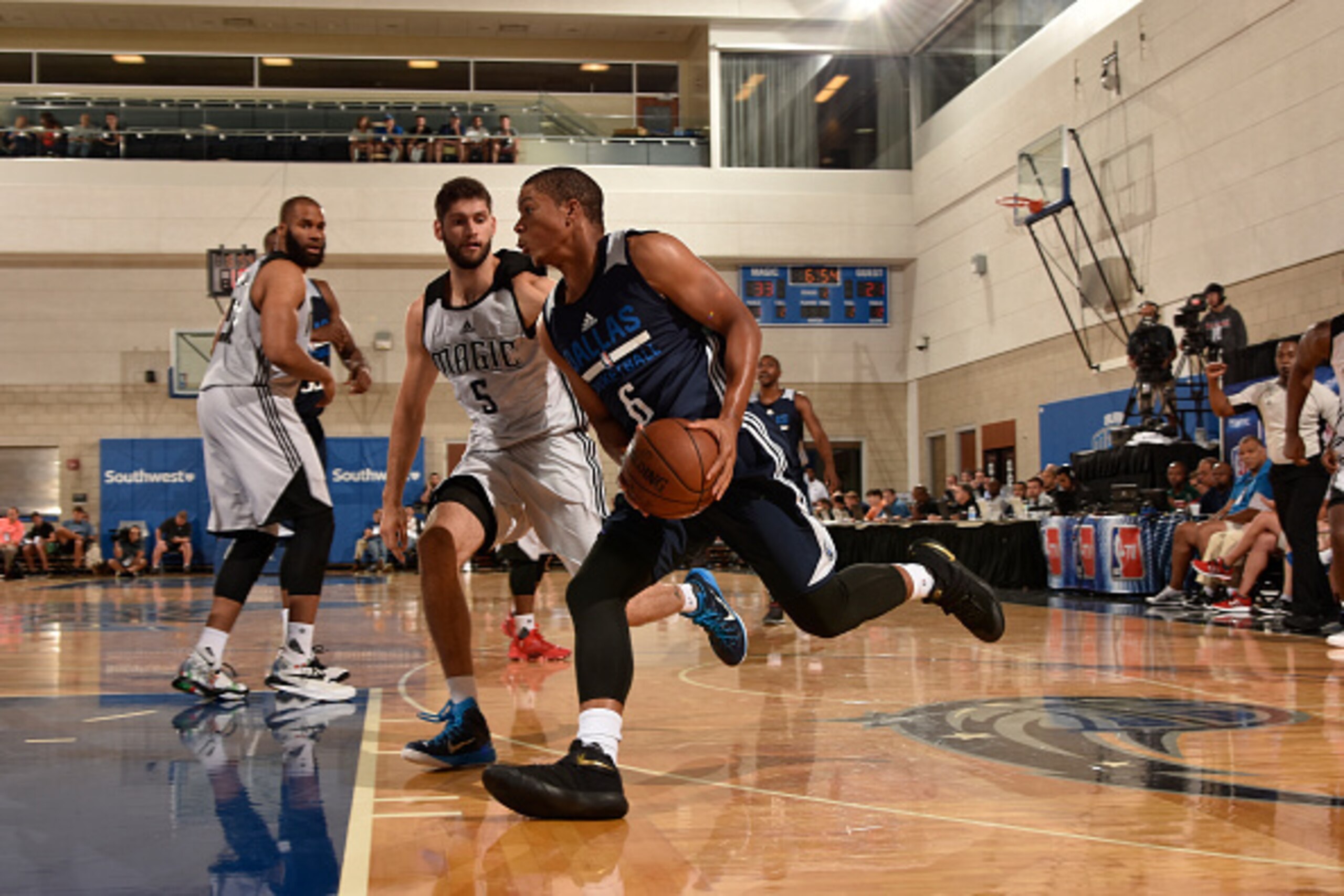 ORLANDO, FL - JULY 4: Andre Dawkins #6 of the Dallas Mavericks drives to the basket against Patricio Garino #5 of the Orlando Magic White during the Orlando Summer League on July 4, 2016 at Amway Center in Orlando, Florida. NOTE TO USER: User expressly a ORLANDO, FL - JULY 4: Andre Dawkins #6 of the Dallas Mavericks drives to the basket against Patricio Garino #5 of the Orlando Magic White during the Orlando Summer League on July 4, 2016 at Amway Center in Orlando, Florida. NOTE TO USER: User expressly a