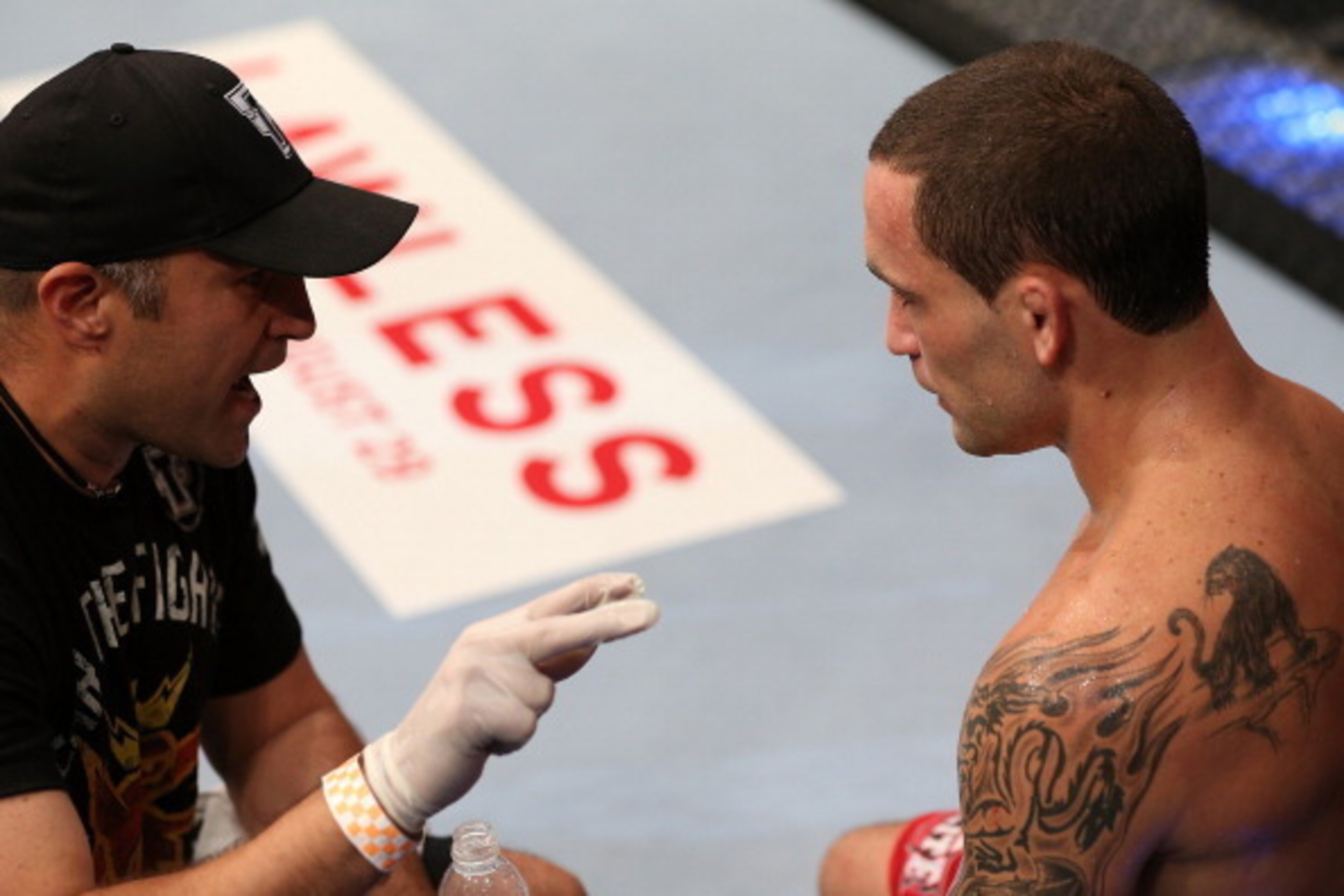 DENVER, CO - AUGUST 11:  Frankie Edgar (R) receives instructions from his corner man between rounds of his fight against Benson Henderson at UFC 150 inside Pepsi Center on August 11, 2012 in Denver, Colorado. (Photo by Josh Hedges/Zuffa LLC/Zuffa LLC via 