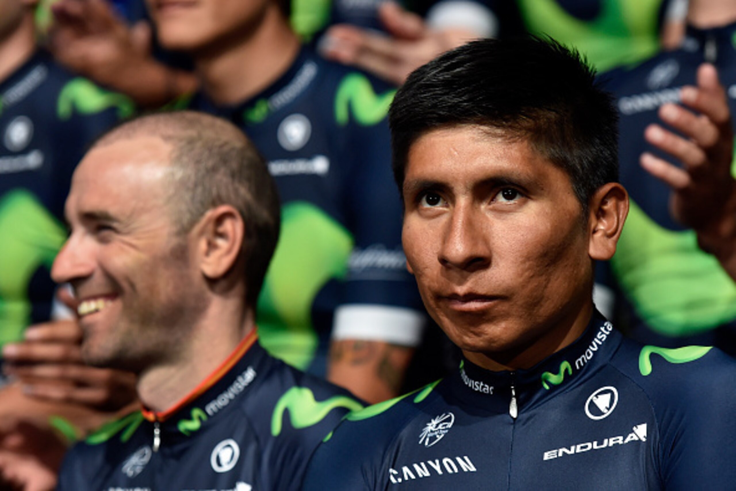 Movistar's Colombian rider Nairo Quintana (R) looks on past Spanish rider Alejandro Valverde during the presentation of the 2016 Movistar Cycling Team in Madrid on January 27, 2016.   AFP PHOTO/ GERARD JULIEN / AFP / GERARD JULIEN        (Photo credit sho