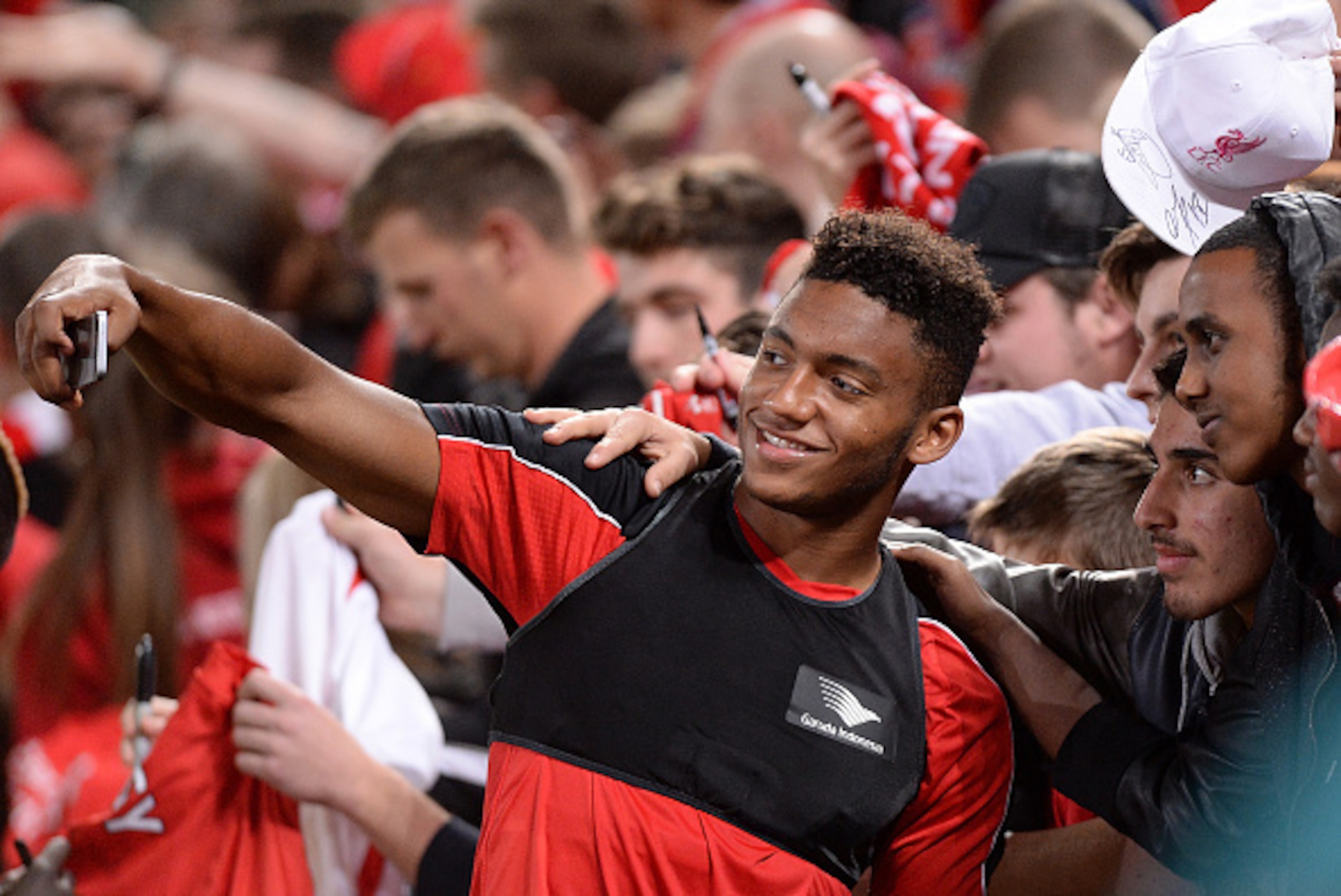 BRISBANE, AUSTRALIA - JULY 16: Joe Gomez takes a selfie with fans during a Liverpool FC training session at Suncorp Stadium on July 16, 2015 in Brisbane, Australia.  (Photo by Bradley Kanaris/Getty Images)