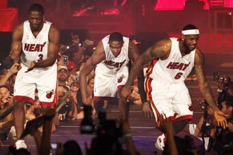 MIAMI - JULY 09:  Fans cheer as (L-R) Dwyane Wade #3, Chris Bosh #1 and LeBron James #6 of the Miami Heat are introduced during a welcome party at American Airlines Arena on July 9, 2010 in Miami, Florida.  (Photo by Marc Serota/Getty Images)