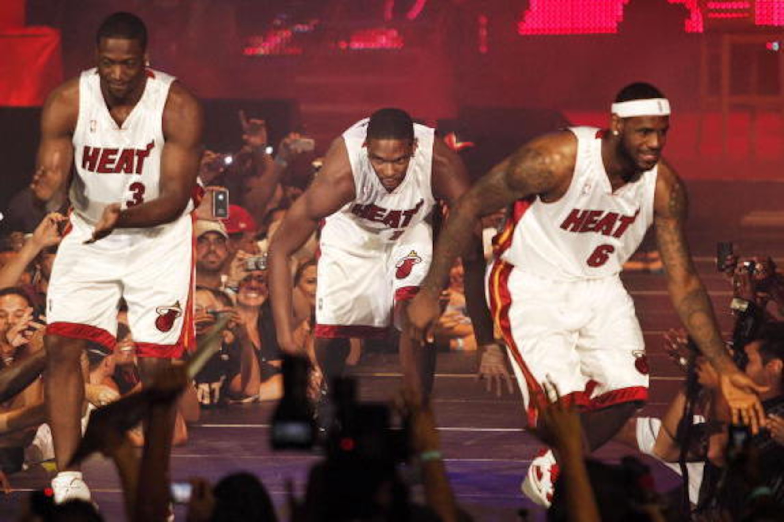 MIAMI - JULY 09:  Fans cheer as (L-R) Dwyane Wade #3, Chris Bosh #1 and LeBron James #6 of the Miami Heat are introduced during a welcome party at American Airlines Arena on July 9, 2010 in Miami, Florida.  (Photo by Marc Serota/Getty Images)