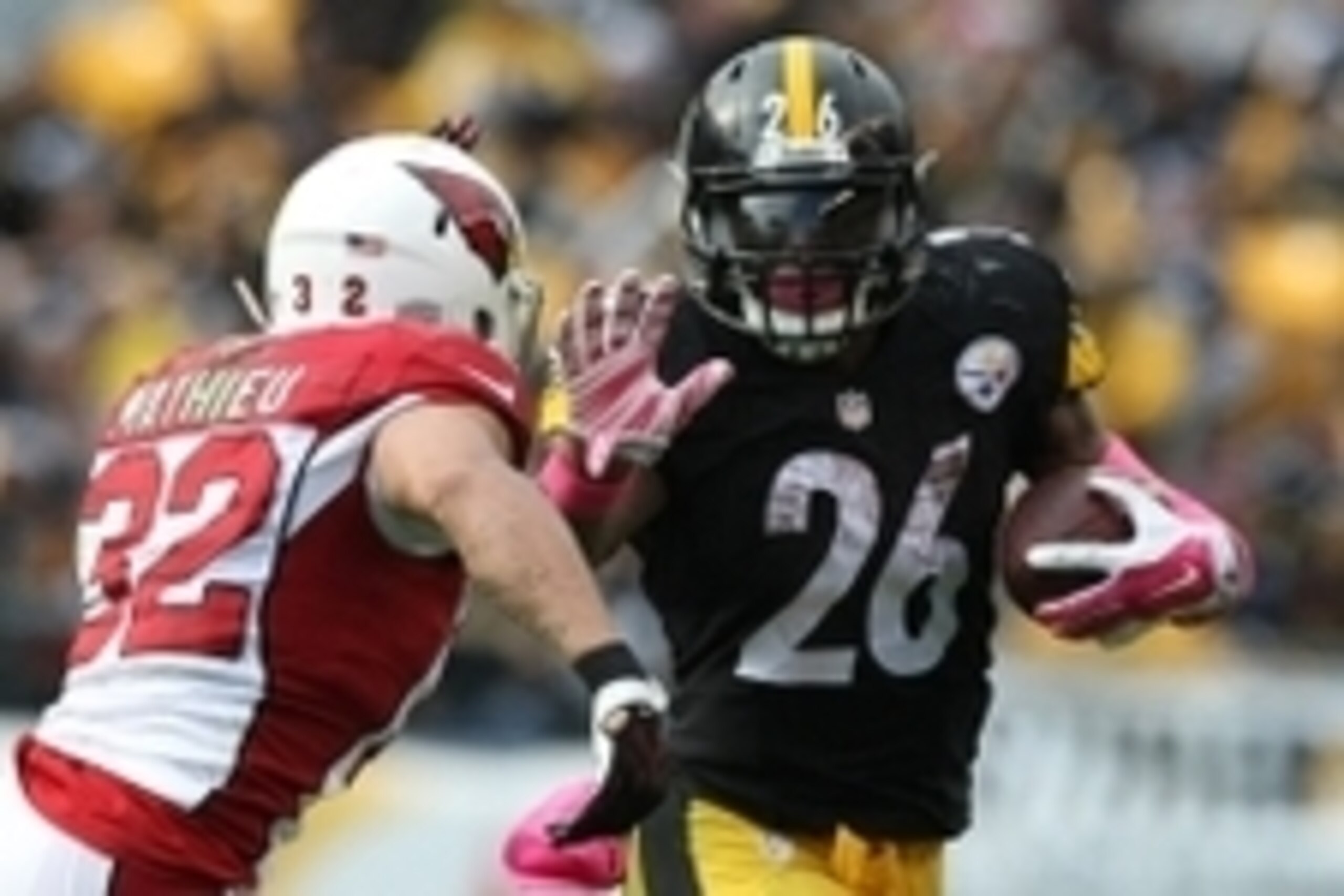 Oct 18, 2015; Pittsburgh, PA, USA; Pittsburgh Steelers running back Le'Veon Bell (26) runs the ball against Arizona Cardinals safety Tyrann Mathieu (32) during the second half at Heinz Field. The Steelers won the game, 25-13. Mandatory Credit: Jason Bridg