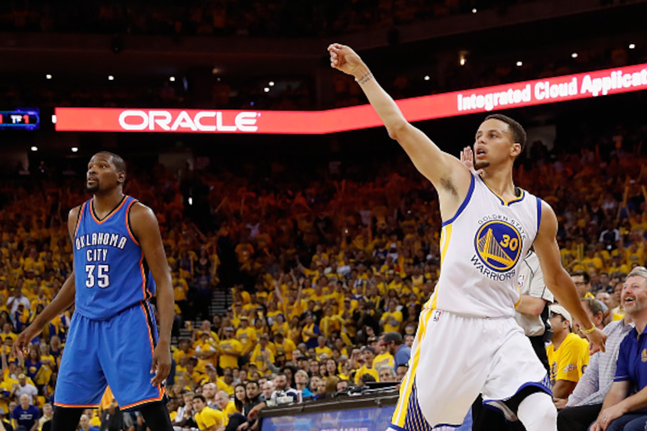 OAKLAND, CA - MAY 18:  Stephen Curry #30 of the Golden State Warriors reacts to a three point shot ahead of Kevin Durant #35 of the Oklahoma City Thunder during game two of the NBA Western Conference Finals at ORACLE Arena on May 18, 2016 in Oakland, Cali