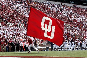 NORMAN, OK - OCTOBER 3:  A member of the Oklahoma Sooners spirit squad celebrates a touchdown against the West Virginia Mountaineers October 3, 2015 at Gaylord Family-Oklahoma Memorial Stadium in Norman, Oklahoma. Oklahoma defeated West Virginia 44-24.(Ph