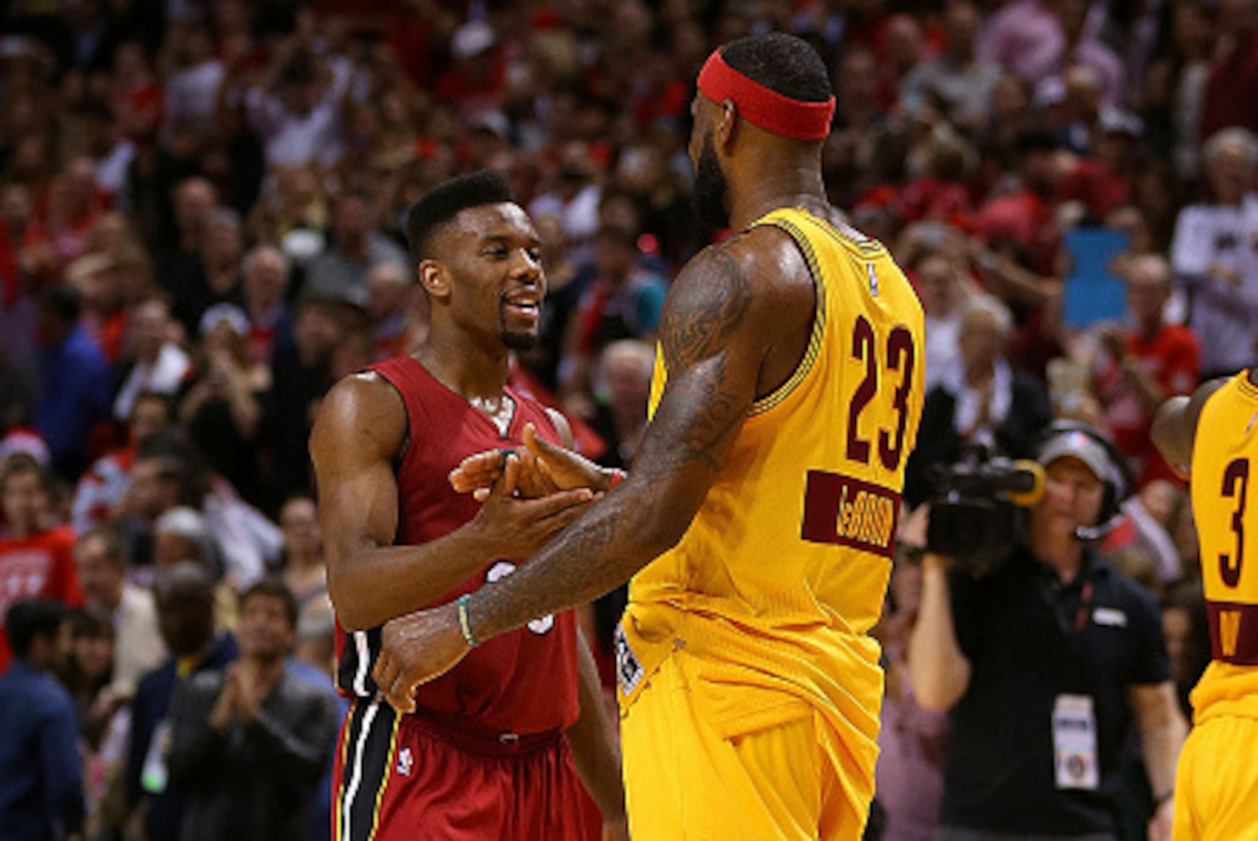 MIAMI, FL - DECEMBER 25: Norris Cole #30 of the Miami Heat and LeBron James #23 of the Cleveland Cavaliers shake hands during a game  at American Airlines Arena on December 25, 2014 in Miami, Florida. NOTE TO USER: User expressly acknowledges and agrees t