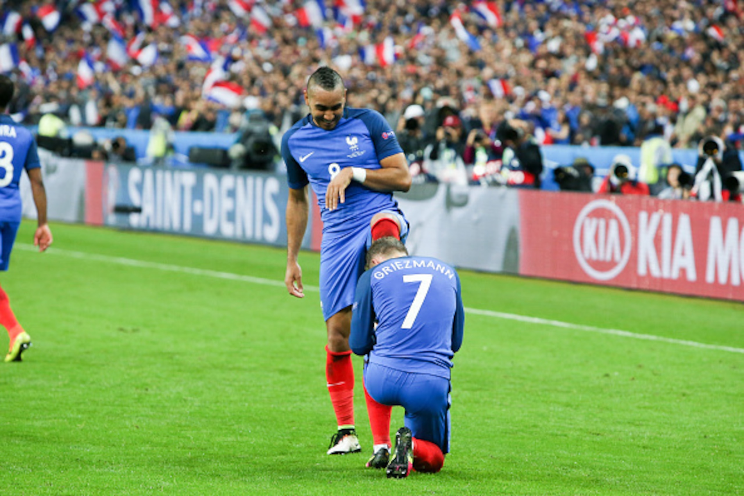 PARIS, FRANCE - JULY 03: Antoine Griezmann #7 kisses the foot of Dimitri Payet #8 of France to celebrate Payet's goal during the UEFA EURO 2016 Quarter Final match between France and Iceland at Stade de France on July 3, 2016 in Paris, France. (Photo by C