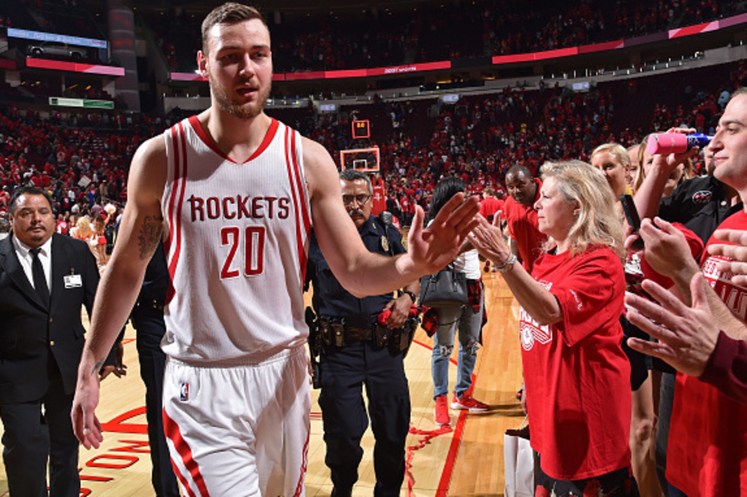 HOUSTON, TX - APRIL 21:  Donatas Motiejunas #20 of the Houston Rockets high fives fans after Game Three of the Western Conference Quarterfinals against the Golden State Warriors during the 2016 NBA Playoffs on April 21, 2016 at the Toyota Center in Housto