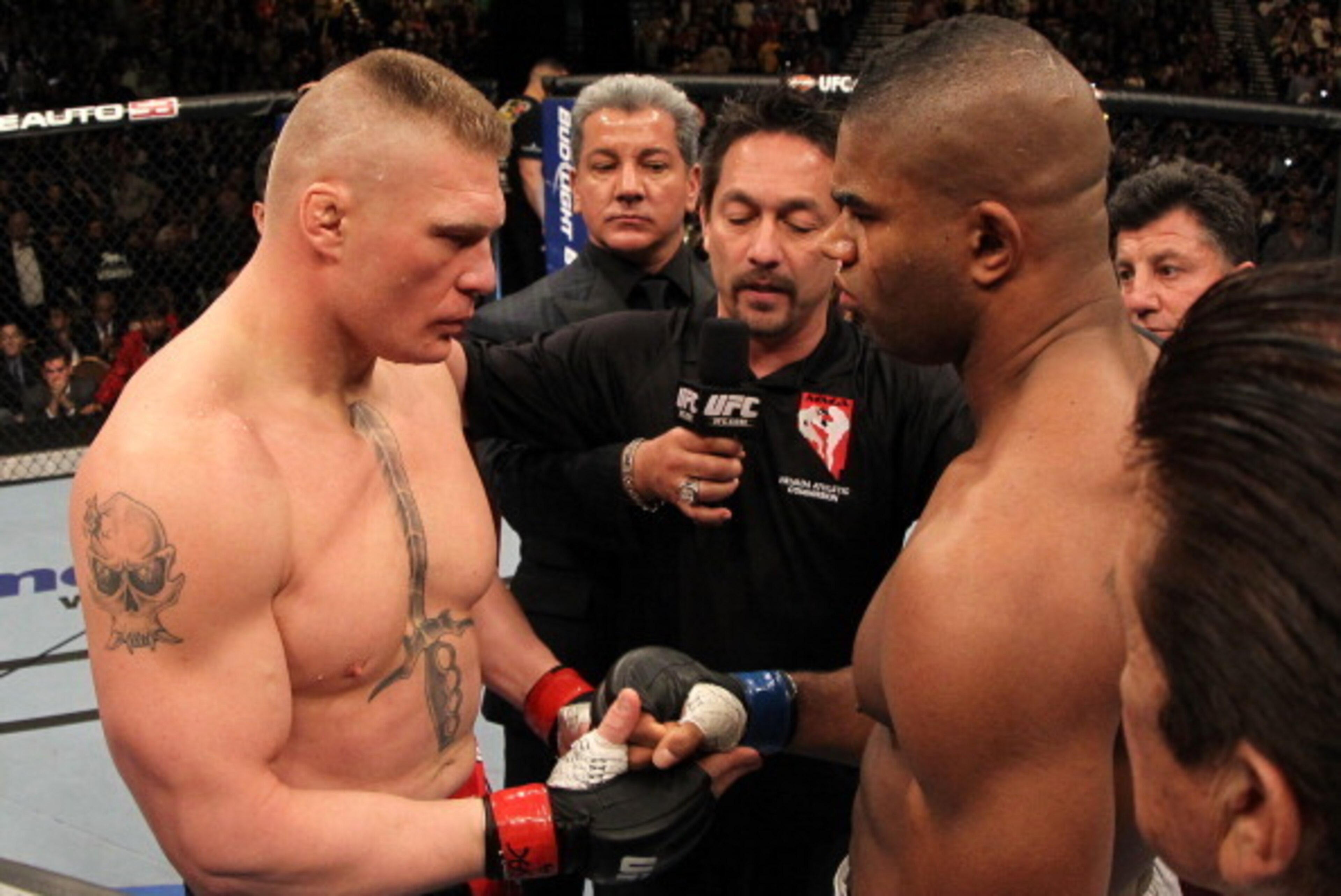 LAS VEGAS, NV - DECEMBER 30:  (L-R) Heavyweight opponents Brock Lesnar and Alistair Overeem receive final instructions from the referee before their main event bout during the UFC 141 event at the MGM Grand Garden Arena on December 30, 2011 in Las Vegas, 