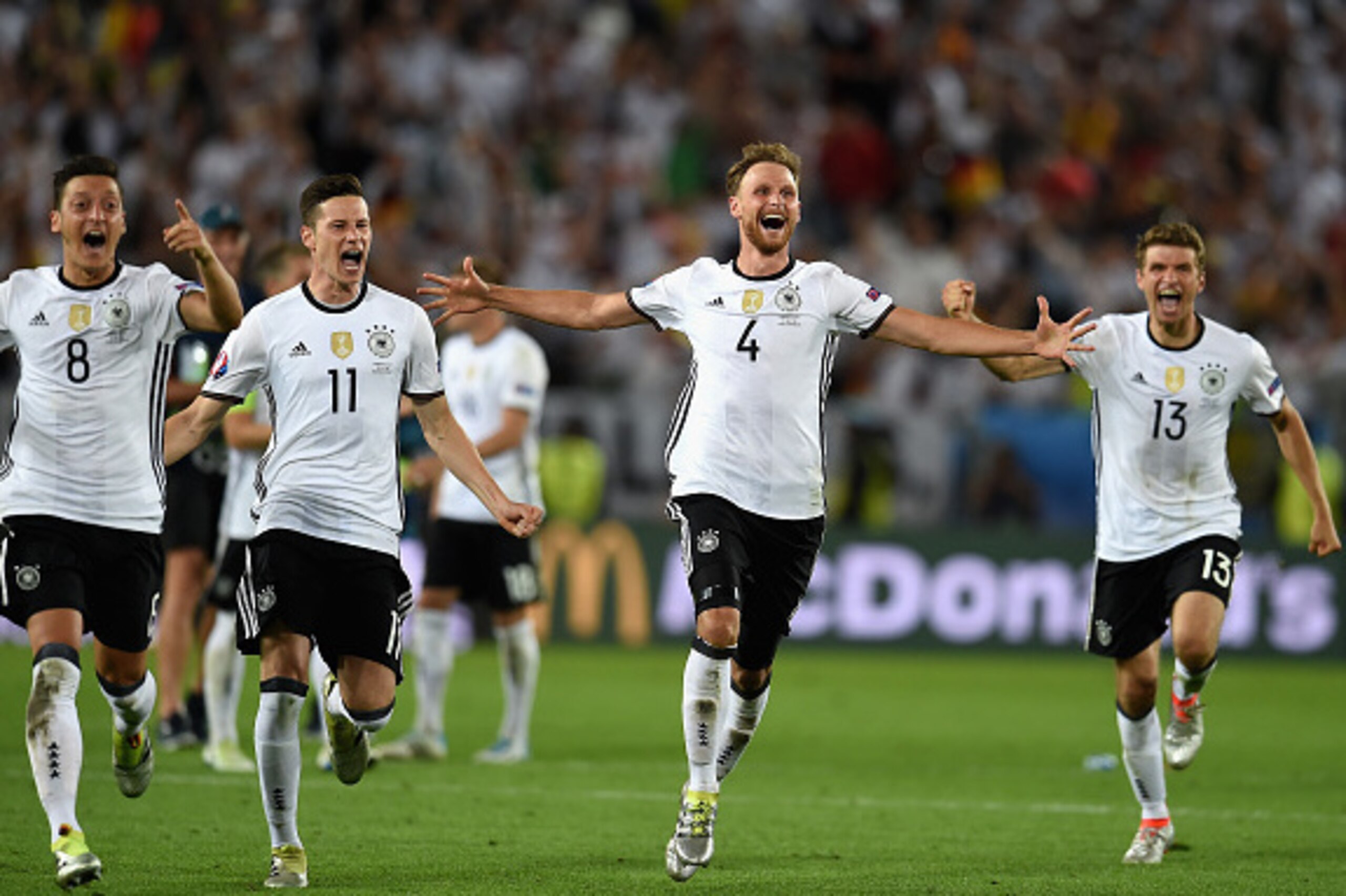 BORDEAUX, FRANCE - JULY 02:  Germany  players dash to celebrate their win through the penalty shootout after Jonas Hector scores to win the game after the UEFA EURO 2016 quarter final match between Germany and Italy at Stade Matmut Atlantique on July 2, 2