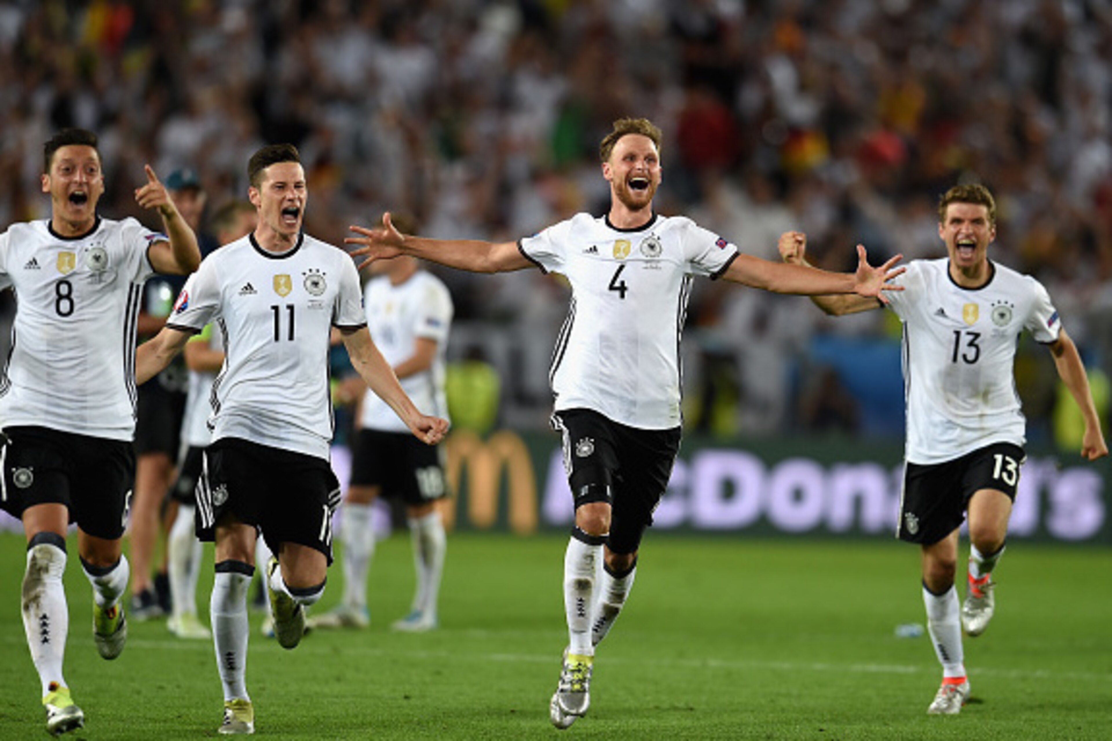 BORDEAUX, FRANCE - JULY 02:  Germany  players dash to celebrate their win through the penalty shootout after Jonas Hector scores to win the game after the UEFA EURO 2016 quarter final match between Germany and Italy at Stade Matmut Atlantique on July 2, 2