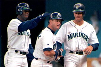 SEATTLE, UNITED STATES:  Seattle Mariners' Edgar Martinez(C) grimaces after he is congratulated by teammates Ken Griffey, Jr.(L) and Alex Rodriguez(R) after Martinez hit a first inning, three-run homer, against the New York Yankees in Seattle 26 May. Seat