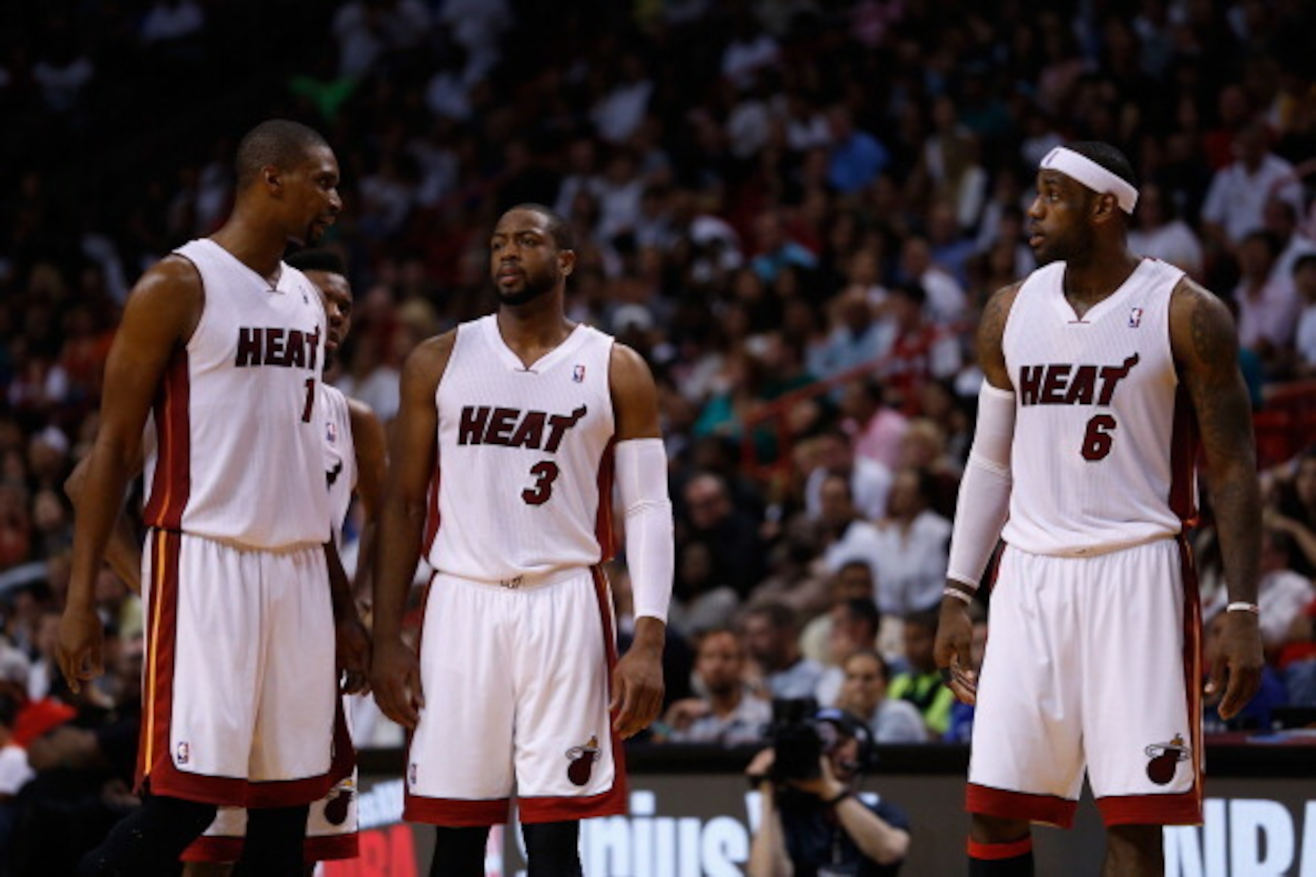 MIAMI, FL - MARCH 16: (L) Chris Bosh #1 of the Miami Heat, (C) Dwyane Wade #3 of the Miami Heat and (R) LeBron James #6 of the Miami Heat look on during a game against the Houston Rockets at American Airlines Arena on March 16, 2014 in Miami, Florida. NOT