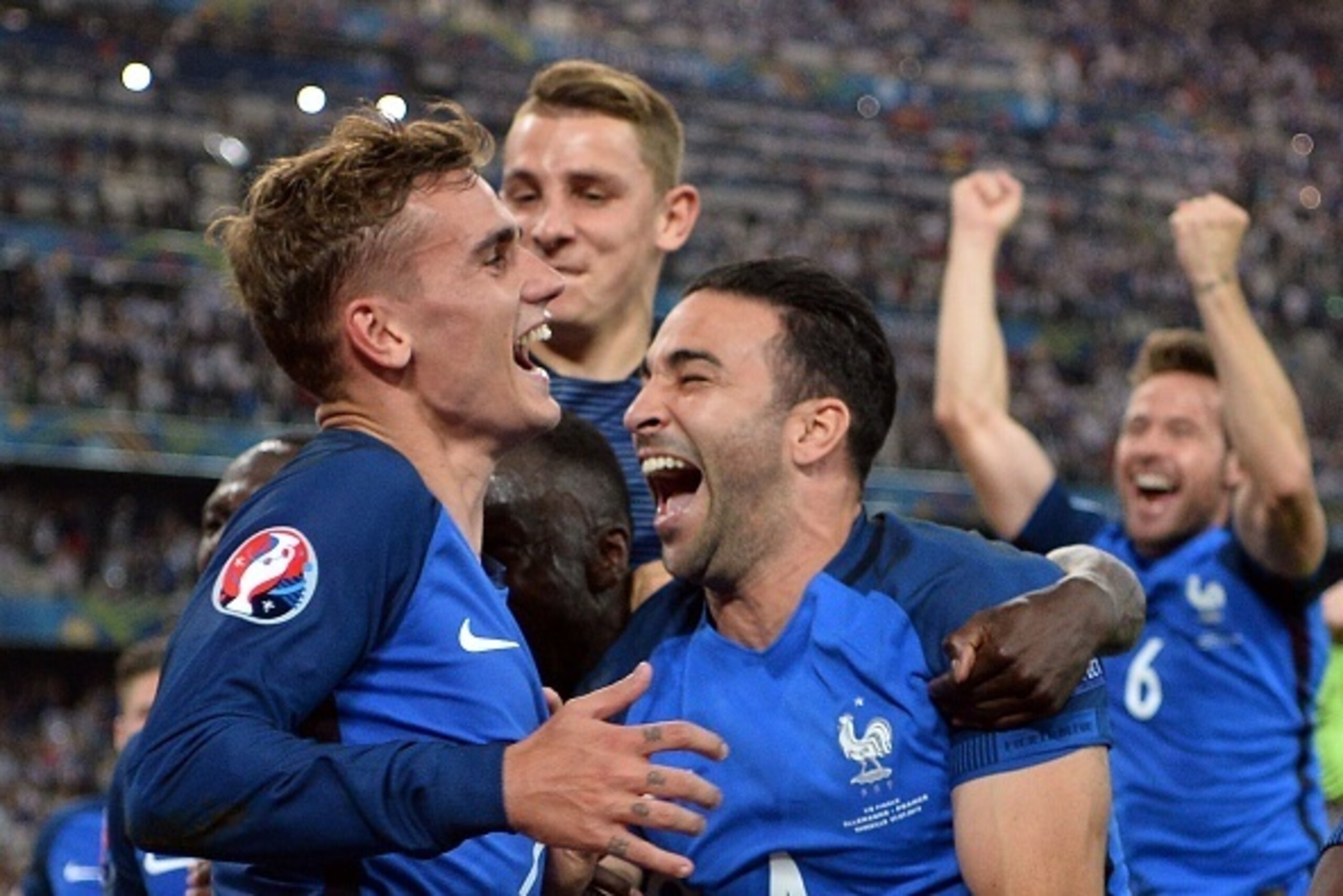 France's forward Antoine Griezmann (L), France's defender Lucas Digne (C) and France's defender Adil Rami (R) celebrate after winning the Euro 2016 semi-final football match between Germany and France at the Stade Velodrome in Marseille on July 7, 2016.