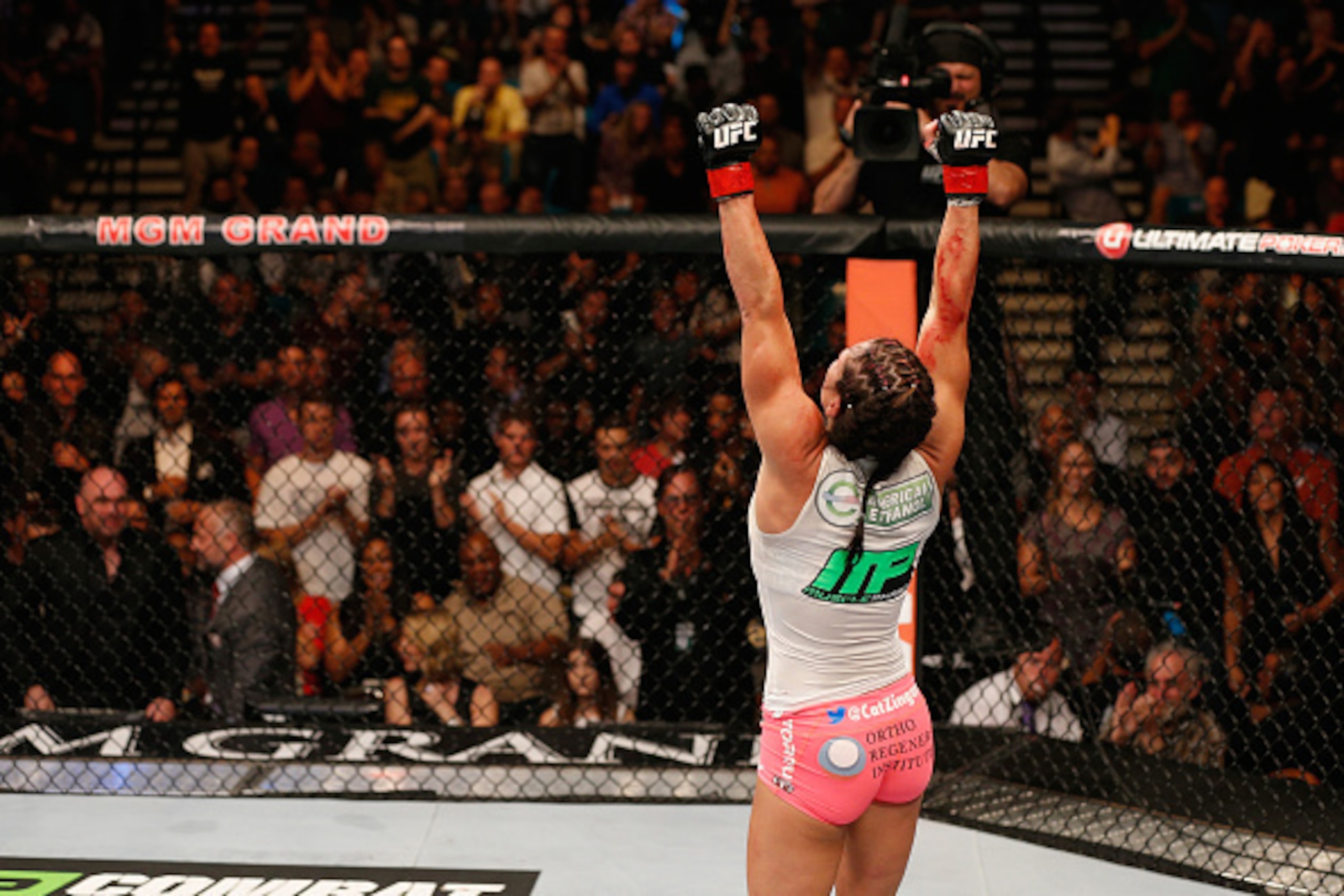 LAS VEGAS, NV - SEPTEMBER 27:  Cat Zingano celebrates after her TKO win over Amanda Nunes in their women's bantamweight fight during the UFC 178 event inside the MGM Grand Garden Arena on September 27, 2014 in Las Vegas, Nevada.  (Photo by Josh Hedges/Zuf