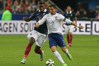 PARIS, FRANCE - OCTOBER 11: Captain Cristiano Ronaldo of Portugal and Paul Pogba of France during the International Friendly Soccer match between France and Portugal at Stade de France on october 11, 2014 in Paris, France. (Photo by Xavier Laine/Getty Ima
