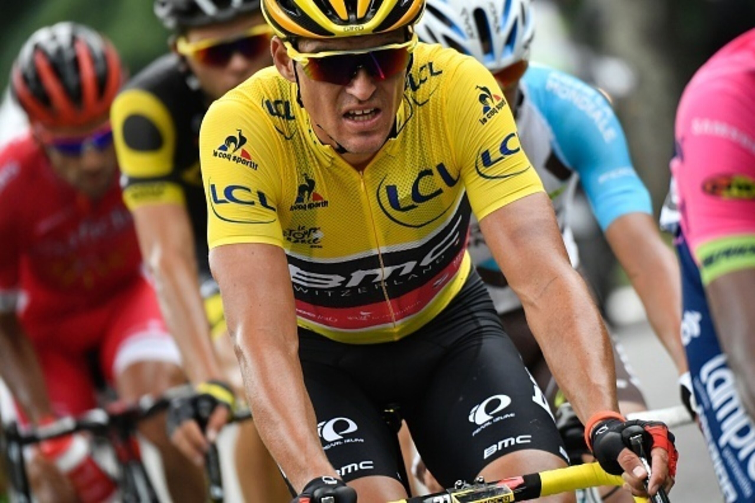 Belgium's Greg Van Avermaet (C), wearing the overall leader's yellow jersey, rides in a breakaway during the 162,5 km seventh stage of the 103rd edition of the Tour de France cycling race on July 8, 2016 between L'Isle-Jourdain and Lac de Payolle.
 / AFP 