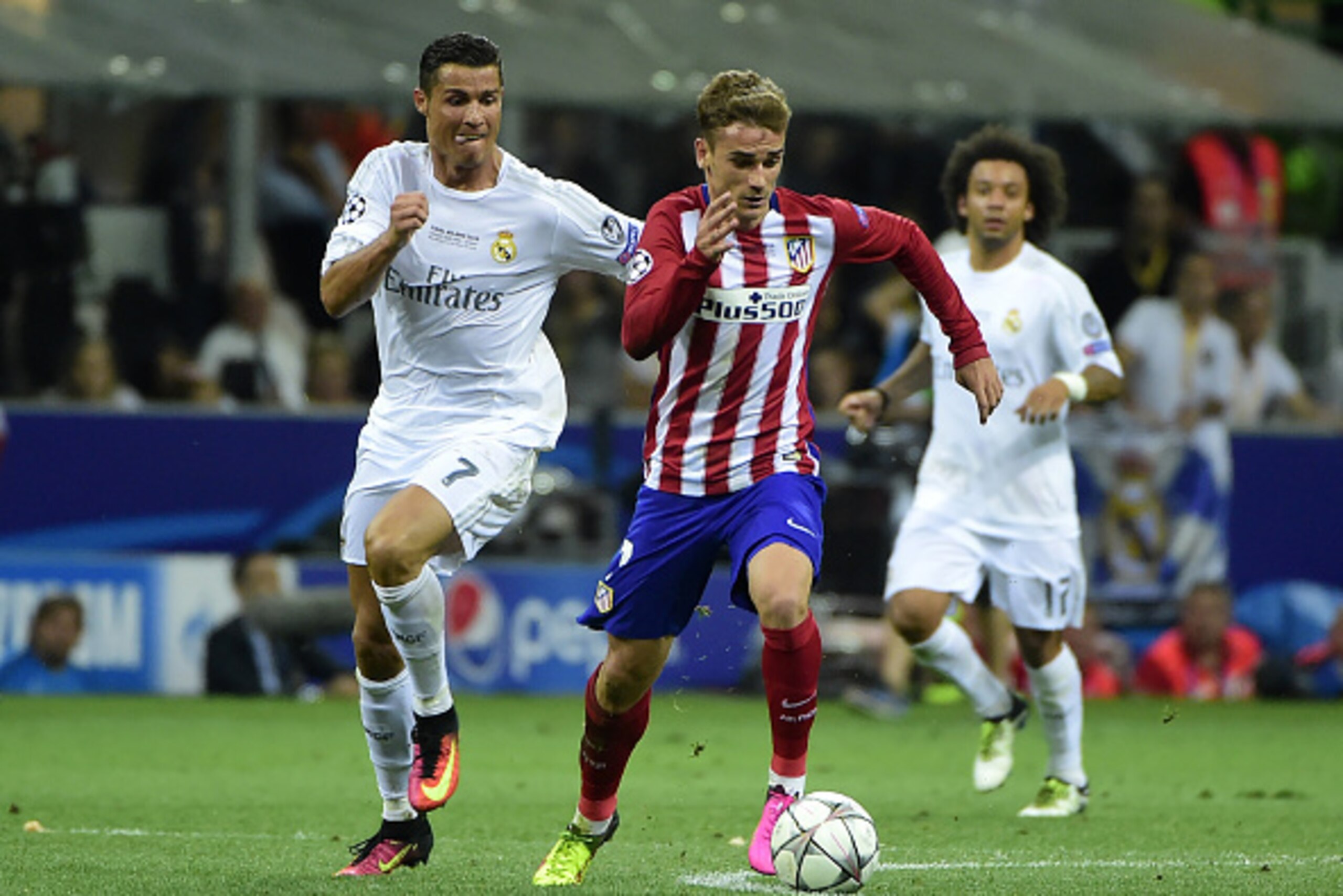 Real Madrid's Portuguese forward Cristiano Ronaldo (L) fights for the ball with Atletico Madrid's French forward Antoine Griezmann during the UEFA Champions League final football match between Real Madrid and Atletico Madrid at San Siro Stadium in Milan, 