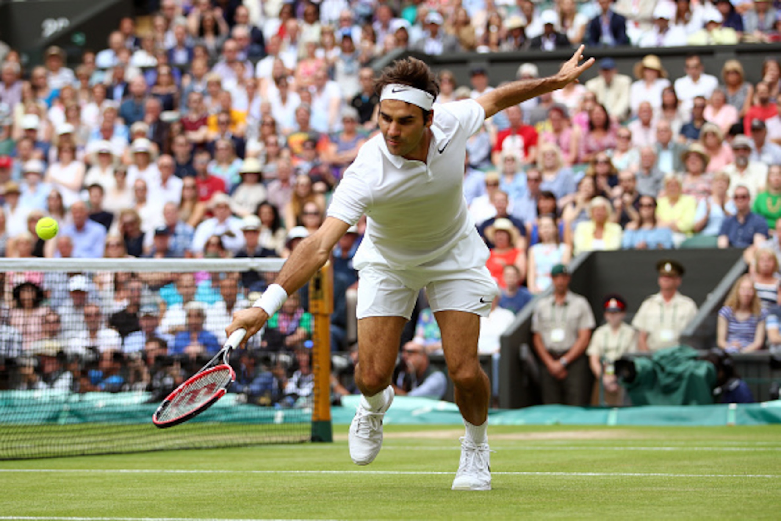 LONDON, ENGLAND - JULY 08:  Roger Federer of Switzerland plays a backhand during the Men's Singles Semi Final match against Milos Raonic of Canada on day eleven of the Wimbledon Lawn Tennis Championships at the All England Lawn Tennis and Croquet Club on 
