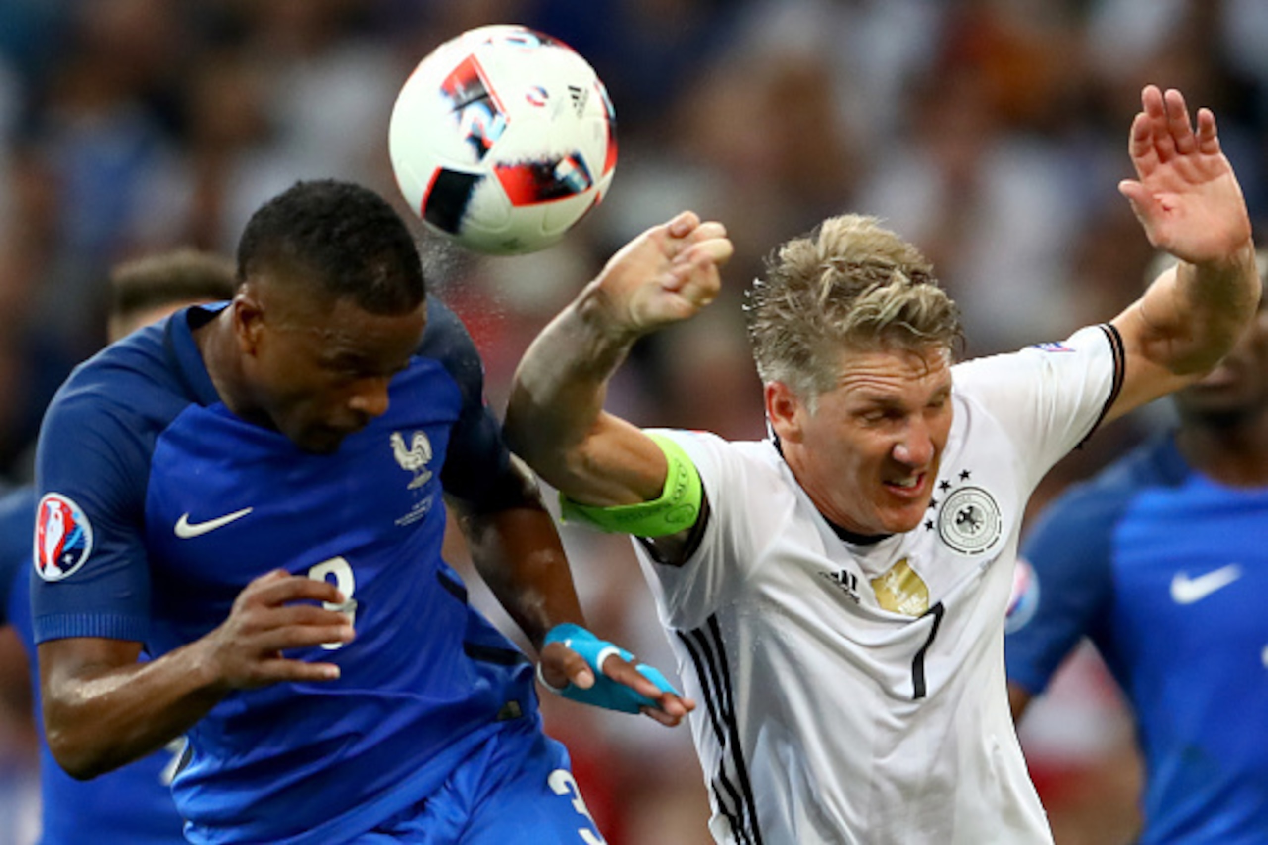 MARSEILLE, FRANCE - JULY 07:  (EDITORS NOTE: Retransmission with alternate crop.)  Bastian Schweinsteiger of Germany handles the ball off the head of Patrice Evra of France during the UEFA EURO semi final match between Germany and France at Stade Velodrom