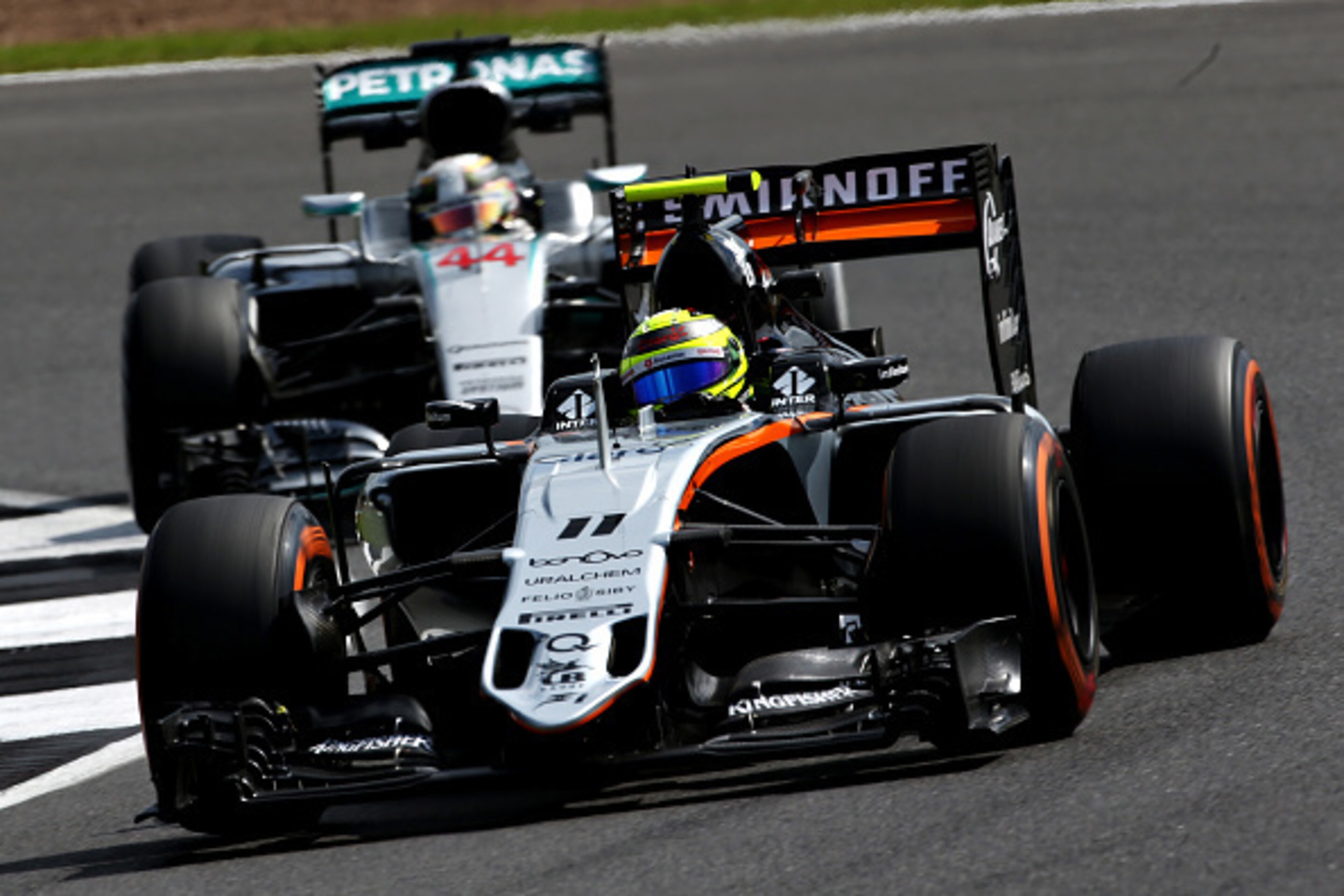 NORTHAMPTON, ENGLAND - JULY 08: Sergio Perez of Mexico driving the (11) Sahara Force India F1 Team VJM09 Mercedes PU106C Hybrid turbo on track ahead of Lewis Hamilton of Great Britain driving the (44) Mercedes AMG Petronas F1 Team Mercedes F1 WO7 Mercedes