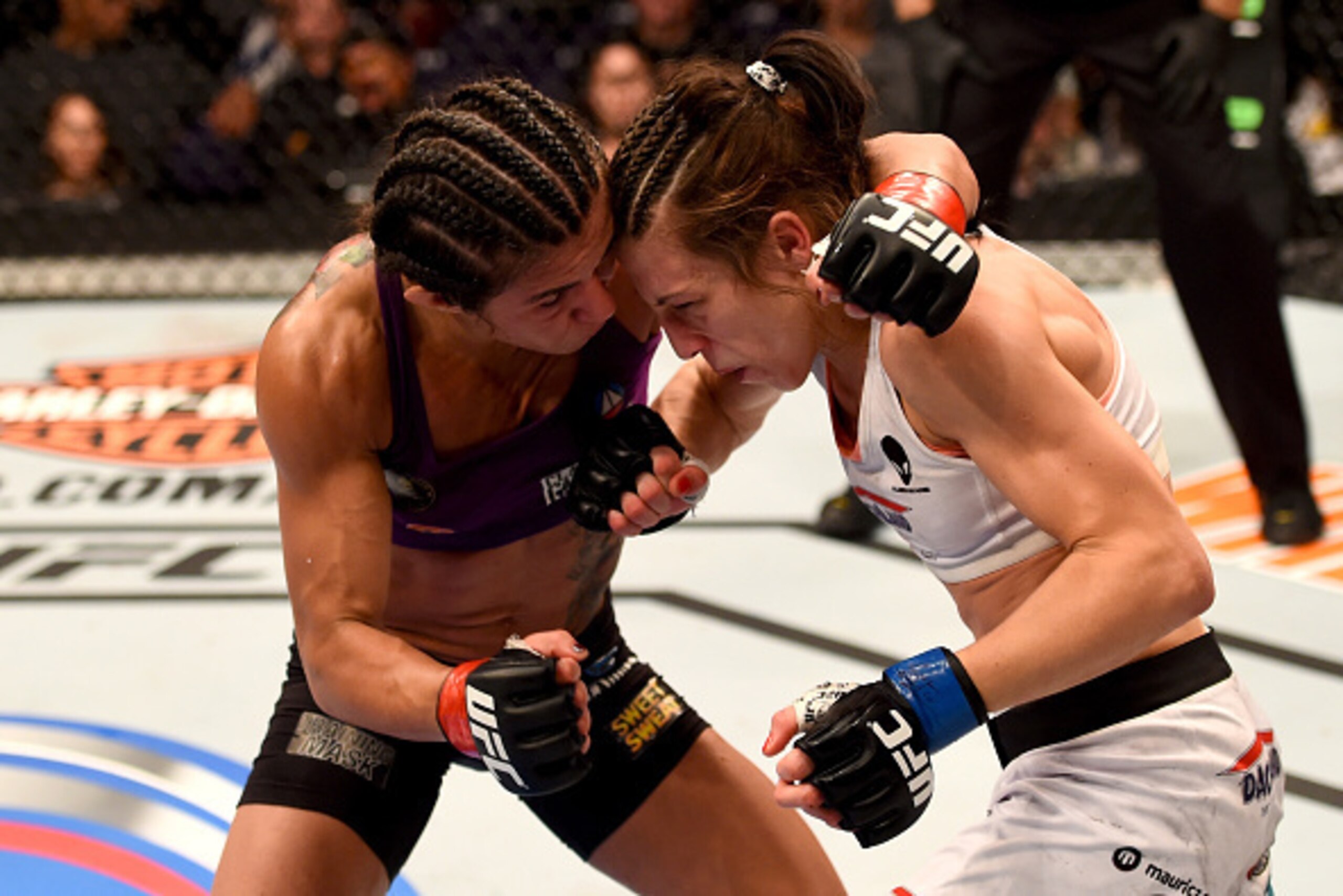 PHOENIX, AZ - DECEMBER 13: (L-R) Claudia Gadelha of Brazil and Joanna Jedrzejczyk of Poland exchange punches in their women's strawweight fight during the UFC Fight Night event at the U.S. Airways Center on December 13, 2014 in Phoenix, Arizona. (Photo PHOENIX, AZ - DECEMBER 13: (L-R) Claudia Gadelha of Brazil and Joanna Jedrzejczyk of Poland exchange punches in their women's strawweight fight during the UFC Fight Night event at the U.S. Airways Center on December 13, 2014 in Phoenix, Arizona. (Photo