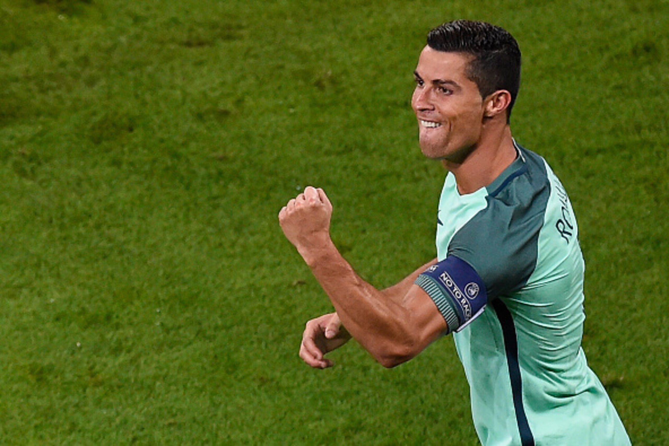 Portugal's forward Cristiano Ronaldo celebrates scoring the opening goal during the Euro 2016 semi-final football match between Portugal and Wales at the Parc Olympique Lyonnais stadium in Décines-Charpieu, near Lyon, on July 6, 2016. / AFP / ROMAIN LAFAB