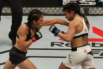 LAS VEGAS, NV - JULY 08:  (L-R) Joanna Jedrzejczyk of Poland punches Claudia Gadelha of Brazil in their UFC women's strawweight championship bout during The Ultimate Fighter Finale event at MGM Grand Garden Arena on July 8, 2016 in Las Vegas, Nevada.  (Ph