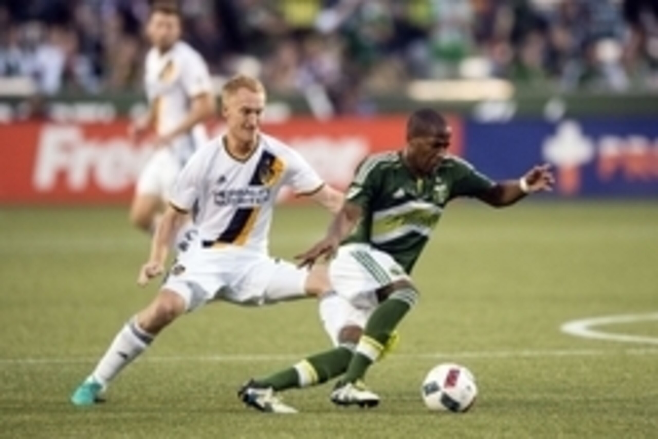 June 29, 2016; Portland, OR, USA; Los Angeles Galaxy midfielder Jeff Larentowicz (21) chases after Portland Timbers midfielder Darlington Nagbe (6) during the second half at Providence Park. The Galaxy won 1-0. Mandatory Credit: Troy Wayrynen-USA TODAY Sp