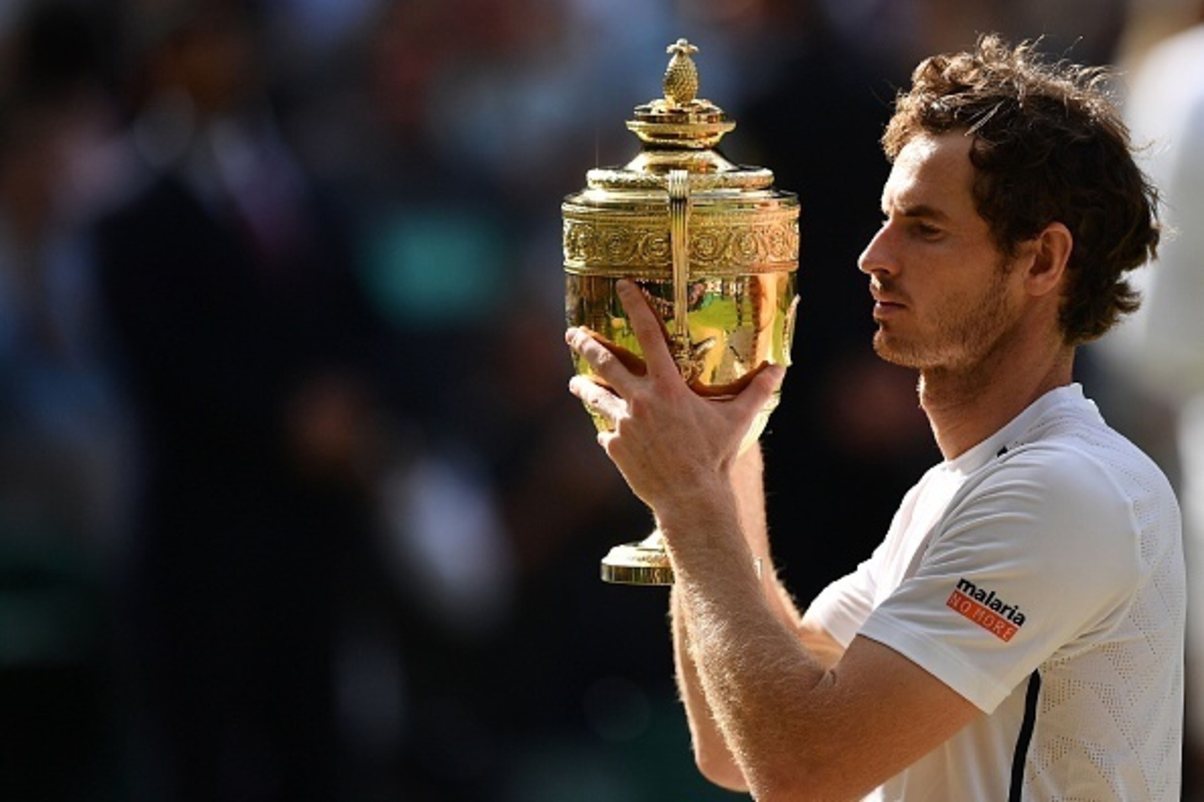 Britain's Andy Murray poses with the winner's trophy after his men's singles final victory over Canada's Milos Raonic on the last day of the 2016 Wimbledon Championships at The All England Lawn Tennis Club in Wimbledon, southwest London, on July 10, 2016.