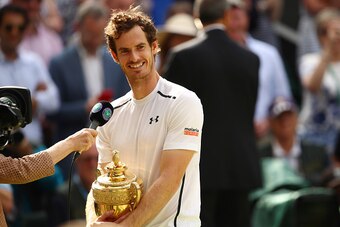 LONDON, ENGLAND - JULY 10:  Andy Murray of Great Britain holds the trophy as he is interviewed following victory in the Men's Singles Final against Milos Raonic of Canada on day thirteen of the Wimbledon Lawn Tennis Championships at the All England Lawn T
