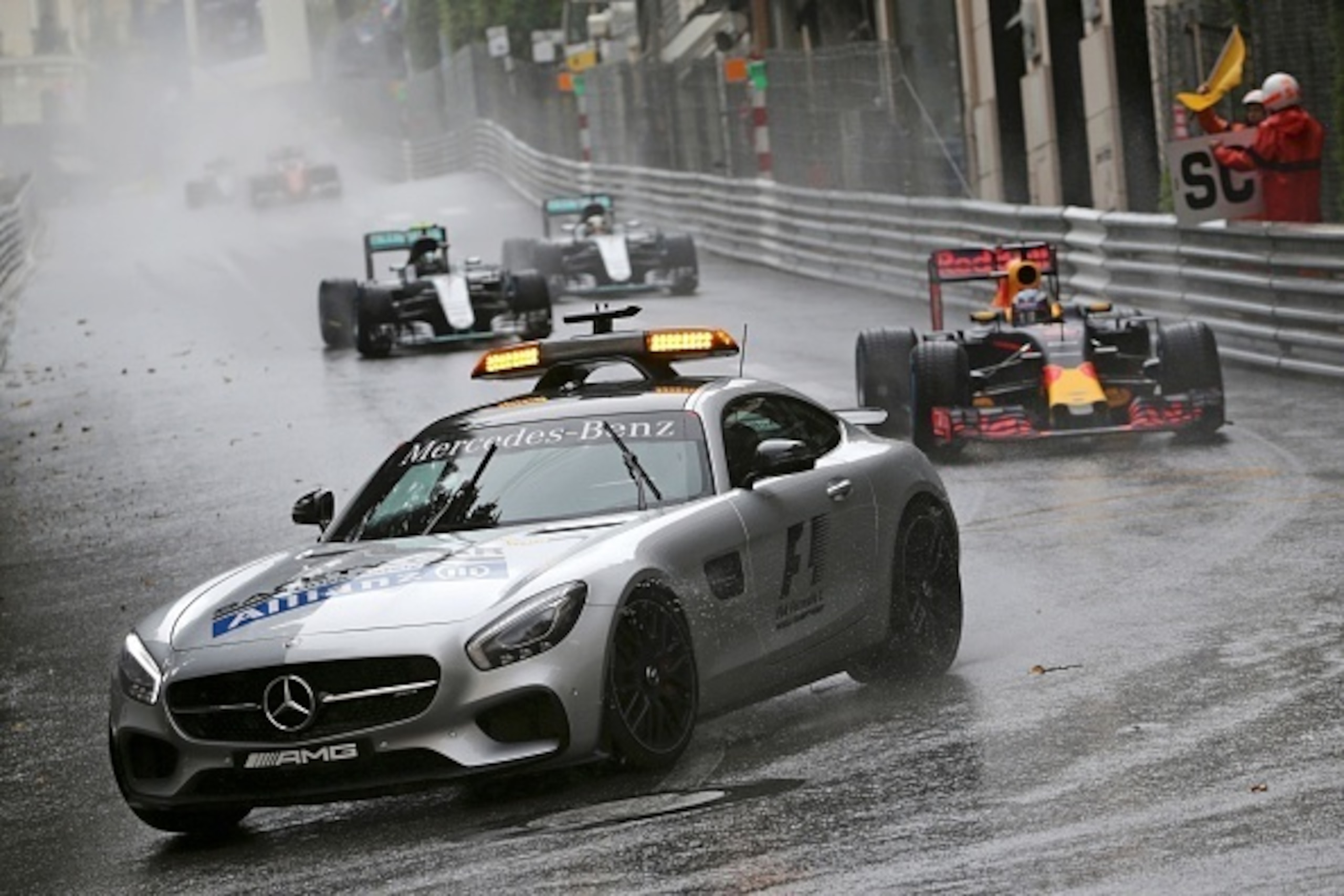 Infiniti Red Bull Racing's Australian driver Daniel Ricciardo, Mercedes AMG Petronas F1 Team's German driver Nico Rosberg and Mercedes AMG Petronas F1 Team's British driver Lewis Hamilton drive behind the safety car at the Monaco street circuit, on May 29