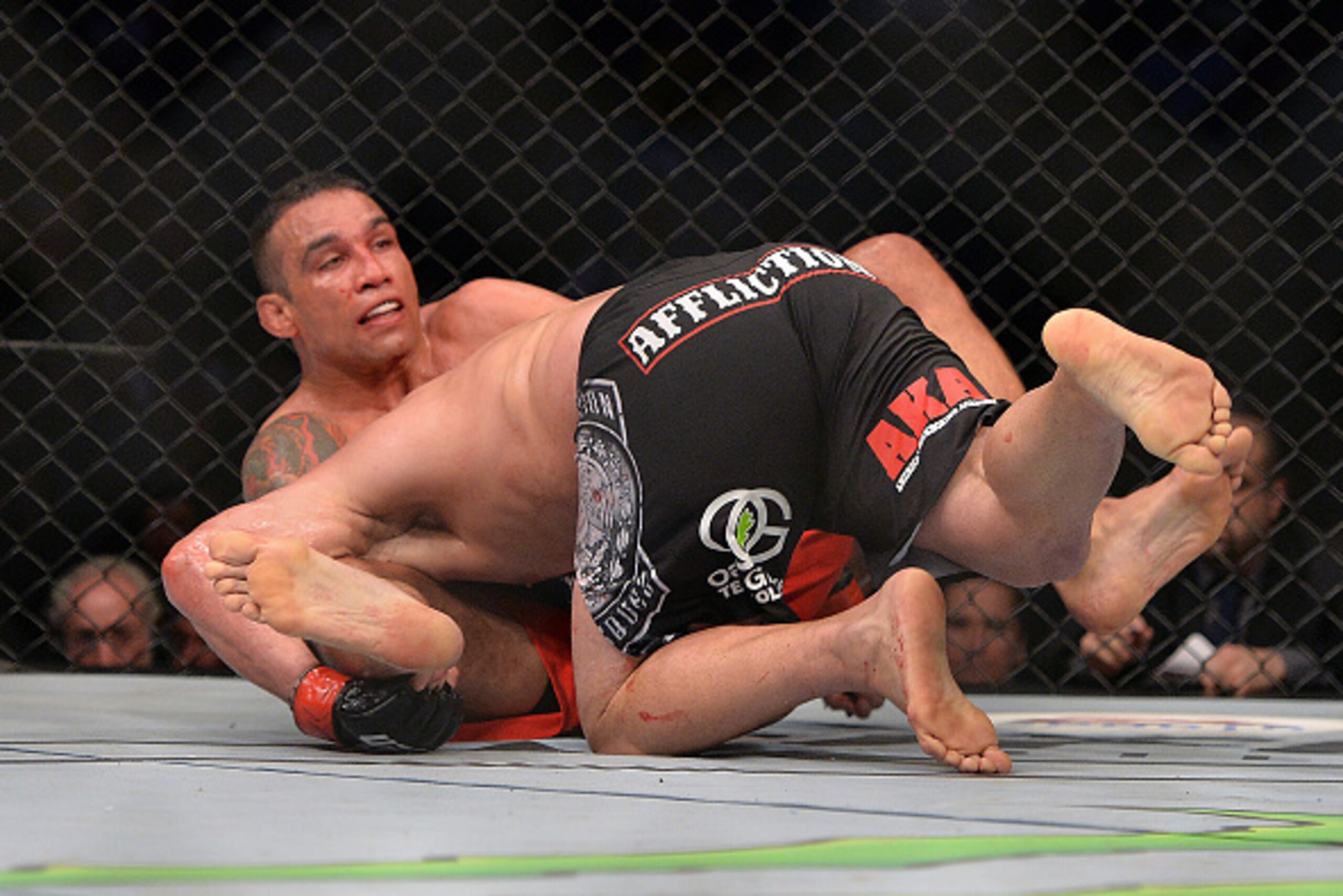 MEXICO CITY, MEXICO - JUNE 13:  (L-R) Fabricio Werdum of Brazil secures a guillotine choke against Cain Velasquez of the United States in their UFC heavyweight championship bout during the UFC 188 event inside the Arena Ciudad de Mexico on June 13, 2015 i