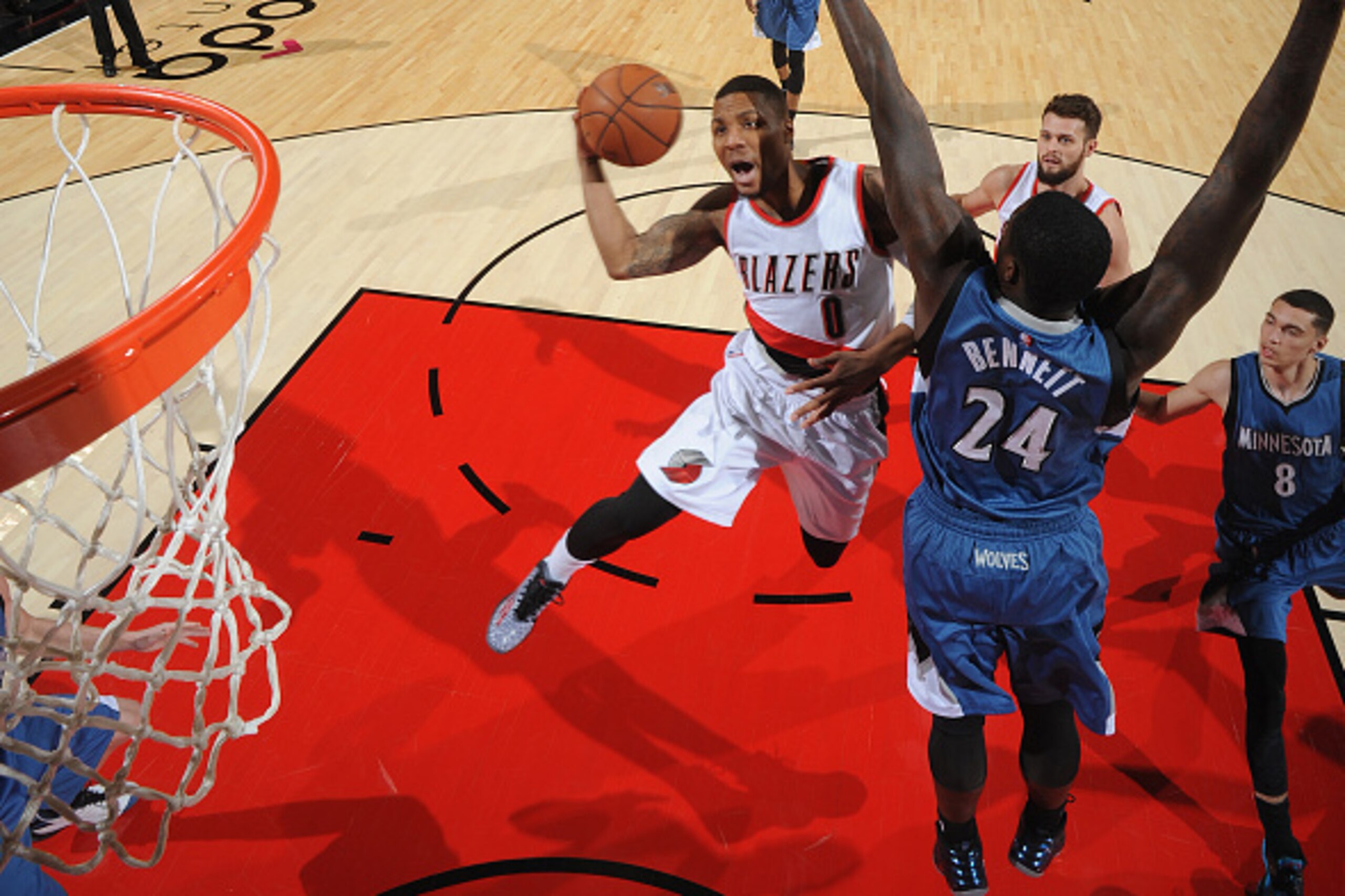 PORTLAND, OR - NOVEMBER 30:  Damian Lillard #0 of the Portland Trail Blazers goes to the basket against Anthony Bennett #24 of the Minnesota Timberwolves on November 30, 2014 at the Moda Center in Portland, Oregon. NOTE TO USER: User expressly acknowledge