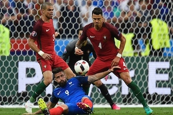 Portugal's defender Pepe (L) and Portugal's defender Fonte vie for the ball with France's forward Olivier Giroud during the Euro 2016 final football match between Portugal and France at the Stade de France in Saint-Denis, north of Paris, on July 10, 2016.