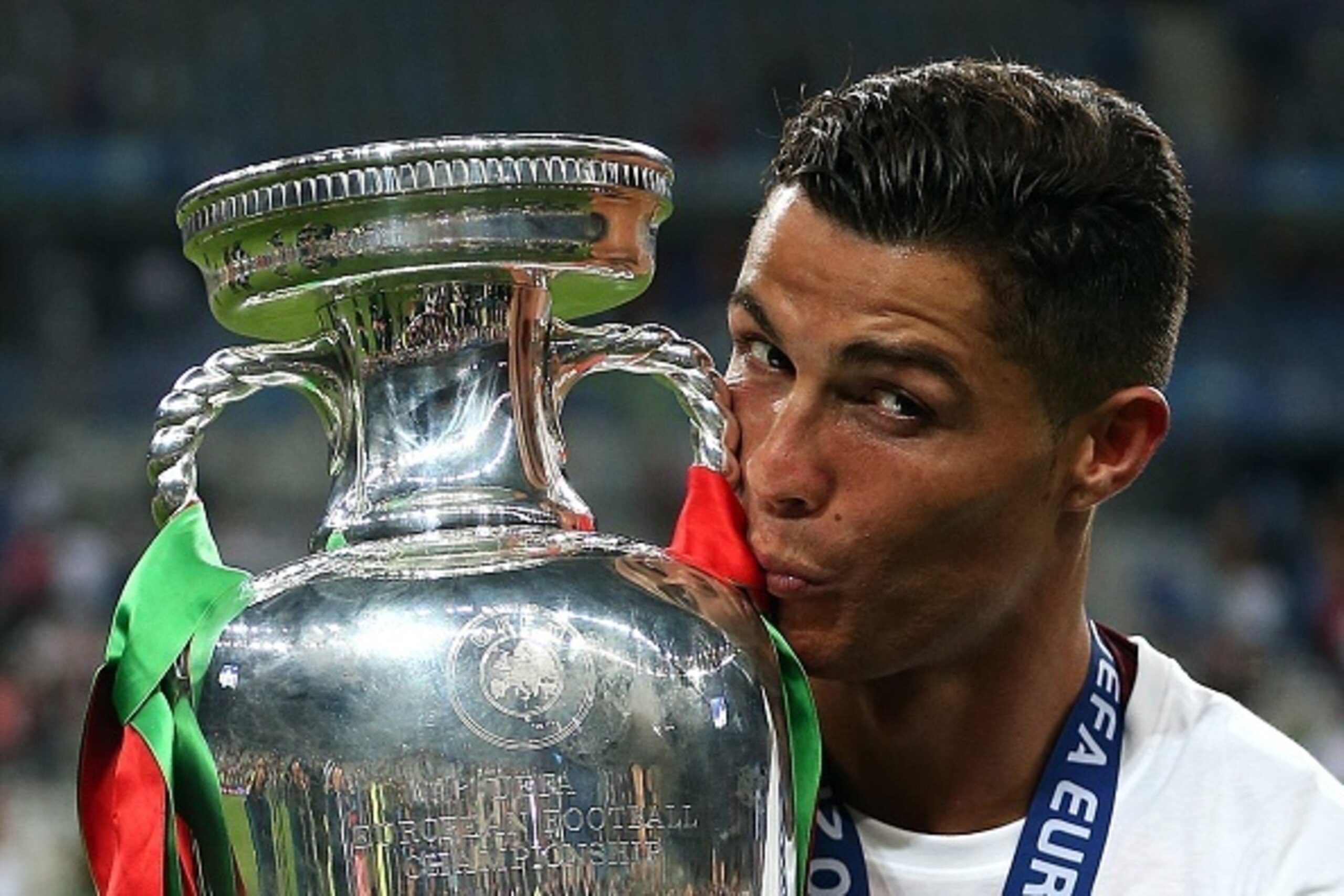 PARIS, FRANCE - JULY 10: Cristiano Ronaldo of Portugal kisses the trophy following the UEFA Euro 2016 Final match between Portugal and France at Stade de France on July 10, 2016 in Paris, France. (Photo by Chris Brunskill Ltd/Getty Images)