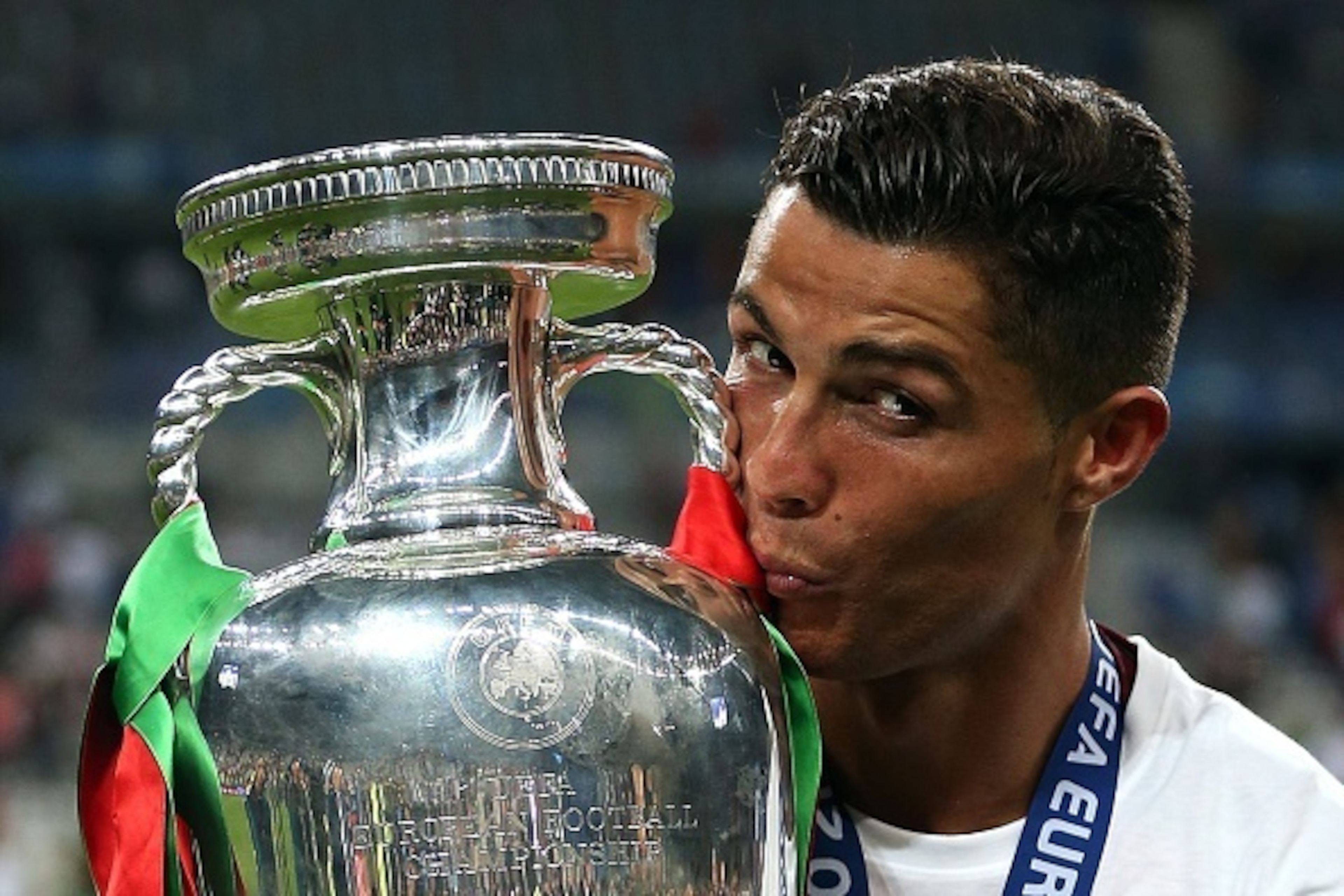 PARIS, FRANCE - JULY 10: Cristiano Ronaldo of Portugal kisses the trophy following the UEFA Euro 2016 Final match between Portugal and France at Stade de France on July 10, 2016 in Paris, France. (Photo by Chris Brunskill Ltd/Getty Images)