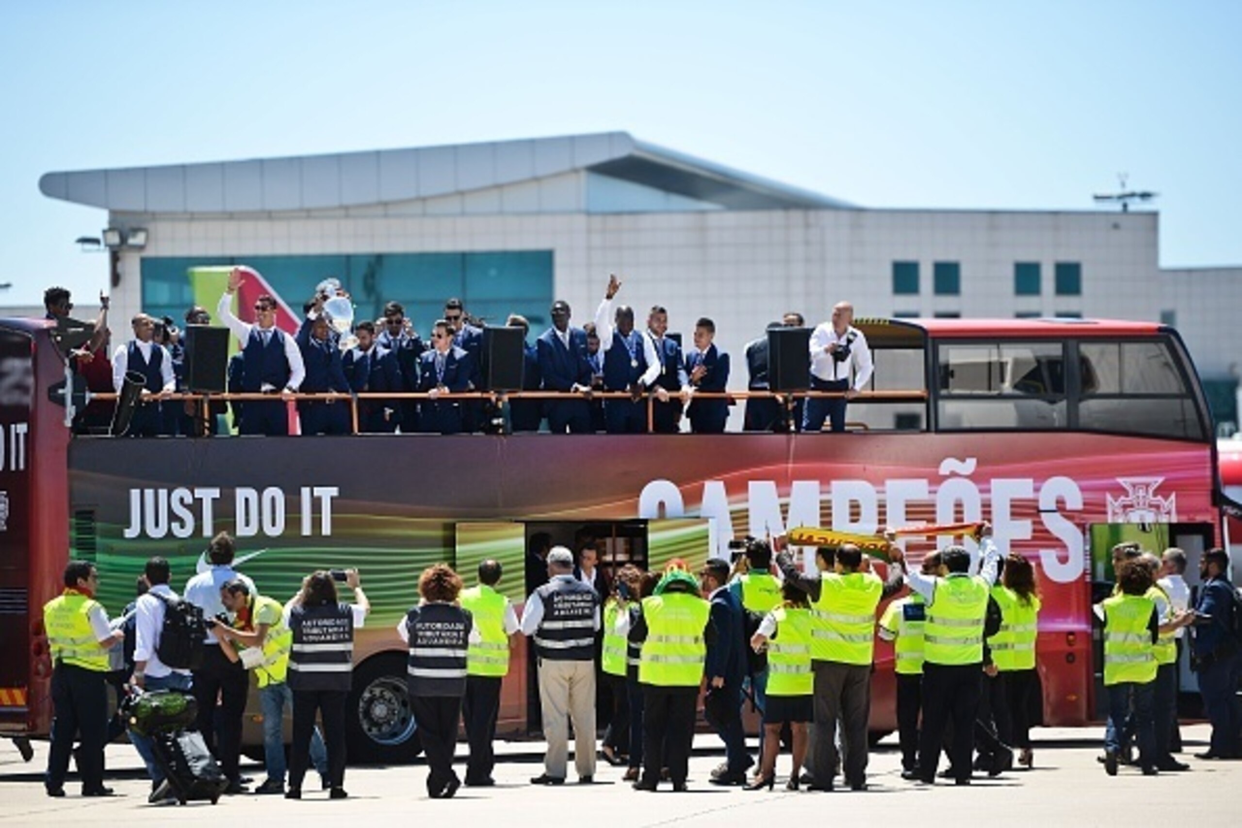 Airport workers welcome Portugal's national football team members riding on an open top bus after their arrival at Lisbon airport on July 11, 2016 after their Euro 2016 final football win over France yesterday.
The Portuguese football team led by Cristian Airport workers welcome Portugal's national football team members riding on an open top bus after their arrival at Lisbon airport on July 11, 2016 after their Euro 2016 final football win over France yesterday.
The Portuguese football team led by Cristian