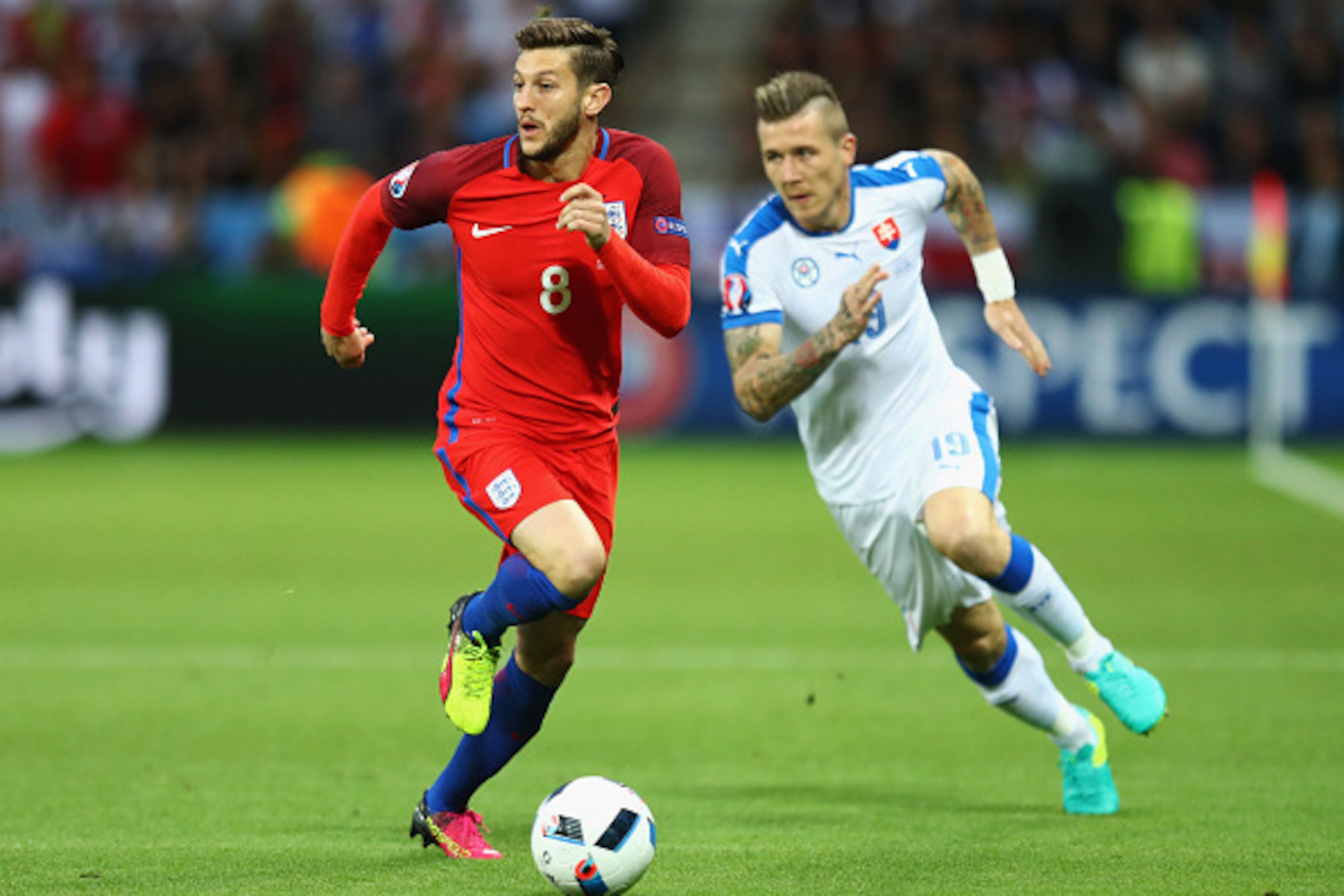 SAINT-ETIENNE, FRANCE - JUNE 20: Adam Lallana of England controls the ball under pressure of Juraj Kucka of Slovakia during the UEFA EURO 2016 Group B match between Slovakia and England at Stade Geoffroy-Guichard on June 20, 2016 in Saint-Etienne, France.