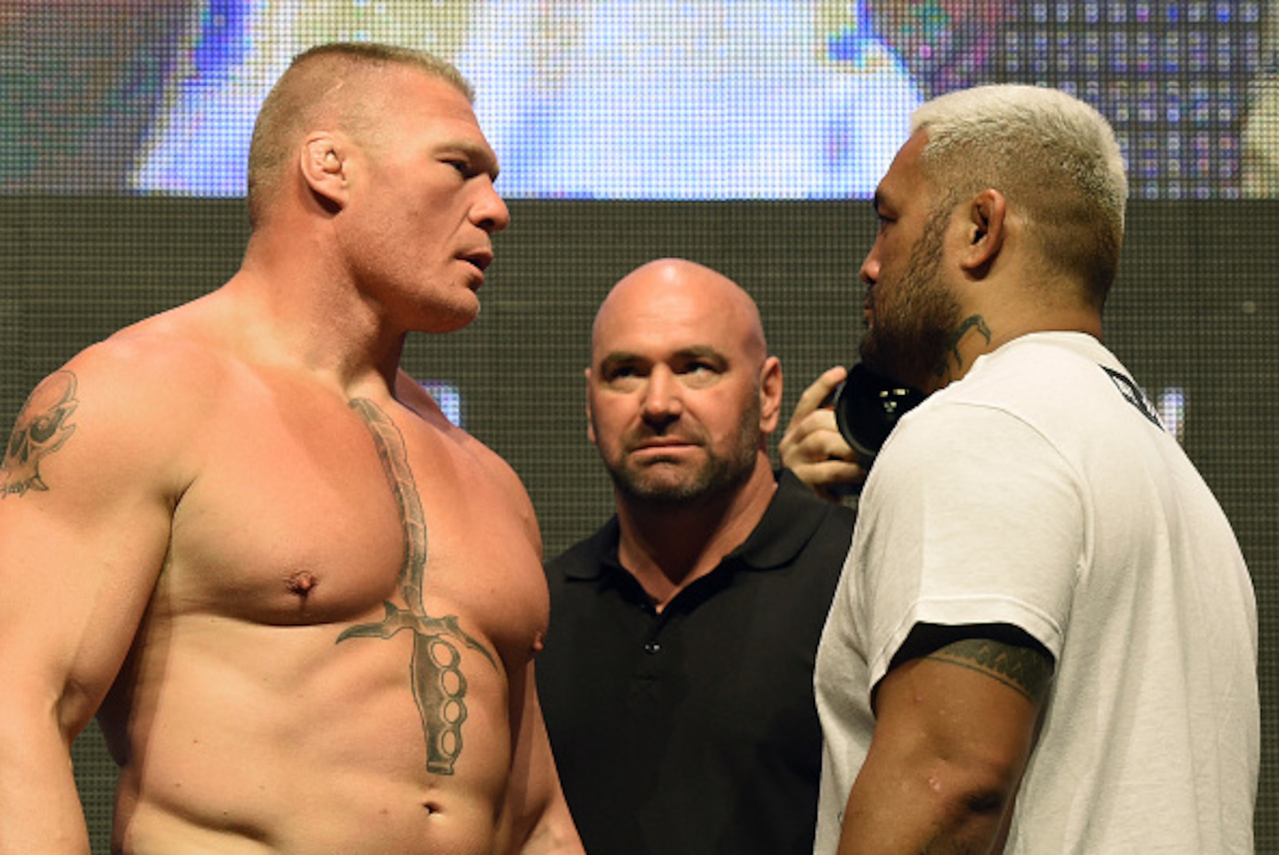LAS VEGAS, NV - JULY 08:  UFC President Dana White (C) looks on as mixed martial artists Brock Lesnar (L) and Mark Hunt (R) face off during their weigh-in for UFC 200 at T-Mobile Arena on July 8, 2016 in Las Vegas, Nevada. The fighters will meet in a heav